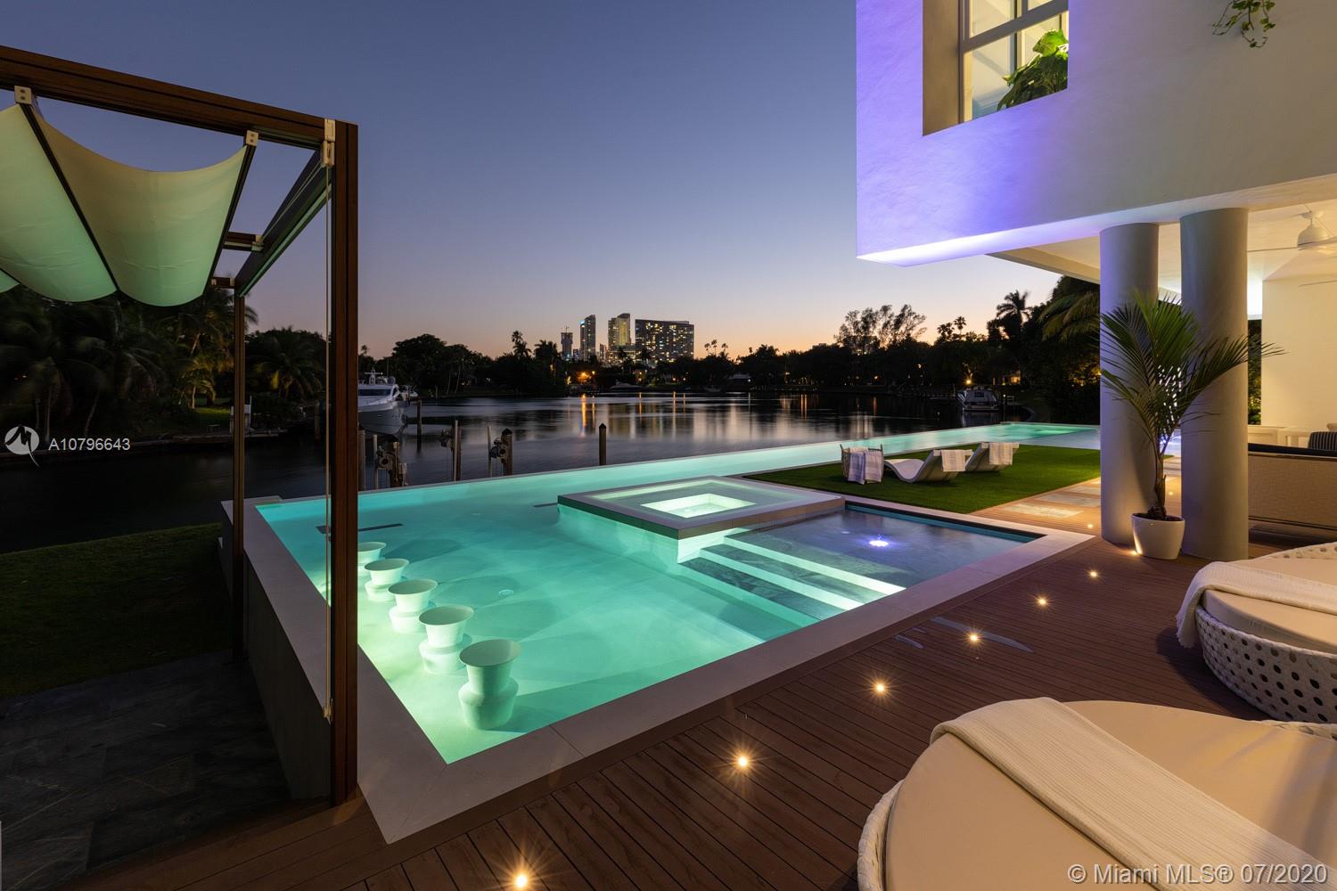 Bay Point Masterpiece: A one-of-a-kind exceptional home, beautifully crafted with exquisite finishes, this Bay Point estate is a modern work of art. The estate features a gorgeous design suited for Miami's indoor-outdoor living, including 7,341 SF of living space, 7 bd, 8.5 ba, 3 car garage + 2 carport spaces with circular driveway, modern kitchen, and stunning custom bar with wine cellar. Fire up the best Gaggenau appliances in the kitchen, and quickly tidy up using innovative hideaway cabinet features by Valcucine. Whether you're enjoying the 74ft infinity lap pool or entertainment areas, you'll spend just as much time outdoors as you do indoors. Located in the most desirable private neighborhood in Miami just mins away from Miami Beach, Downtown, the Design District, & the Miami Airport