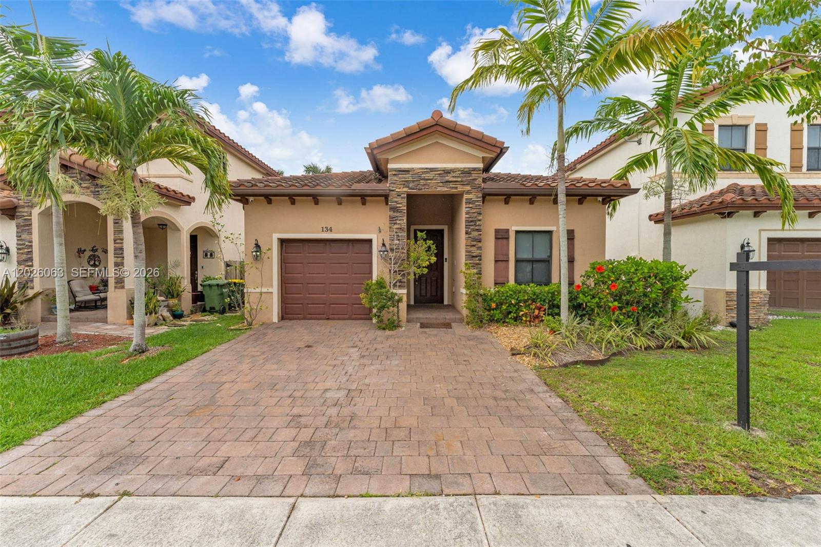 2018 BUILD | SPLIT FLOORPLAN — Why buy older when you can have this? This beautifully maintained 4-bedroom, 2-bathroom home built in 2018 means the roof, AC, and water heater are all young — move in with total peace of mind. High ceilings greet you from the moment you walk in, giving the home an open, airy feel that is hard to replicate. The split floorplan delivers privacy and functionality for the whole family. The kitchen is a standout — anchored by a stunning stone accent wall that adds character and a designer touch you won't find in every home. Step outside to a beautifully pavered backyard, perfect for entertaining or simply unwinding. Nestled in a great Homestead community with everything South Dade has to offer just minutes away. Low maintenance, move-in ready, and built to last.
