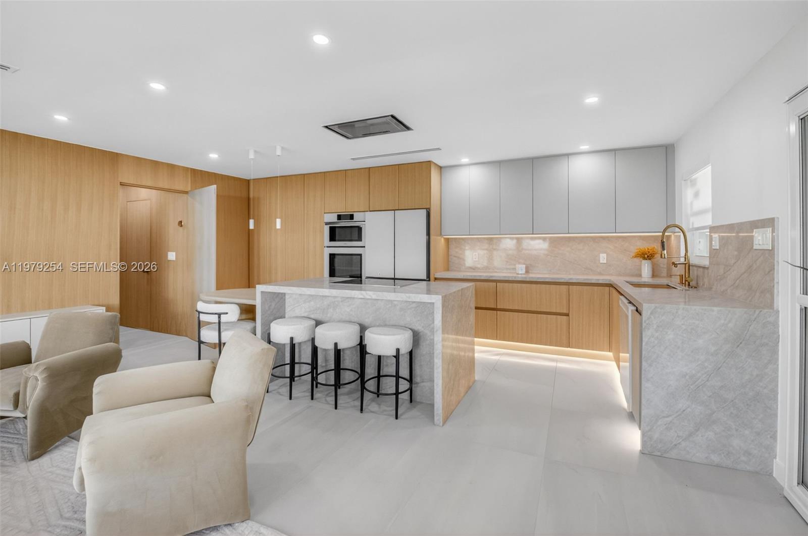 This remodeled condo blends modern efficiency with elegant design. It’s a two-bedroom, two-bath apartment featuring porcelain tiles throughout and a sleek, efficient kitchen with real white oak cabinets, no hardware, a Taj Mahal quartz island with pop-up outlets, and a ceiling-integrated exhaust system for clean lines. Walking past the living area, you enter a dining room surrounded by windows that flood the space with light, complemented by a beautiful chandelier. From there, you return to the living area, which features matching white oak panels ready for a TV. Both bedrooms have white oak cabinetry and en-suite bathrooms with gold-accent mirrors. The master bedroom includes a door to the back patio. Unique features include a private laundry room, new hurricane-proof windows, and fully redone electrical, plumbing, drywall, and HVAC with new ducts. The condo is fully ready to move in, offering a turn-key, luxurious lifestyle.

The unit can be purchased furnished at an additional $25,000.