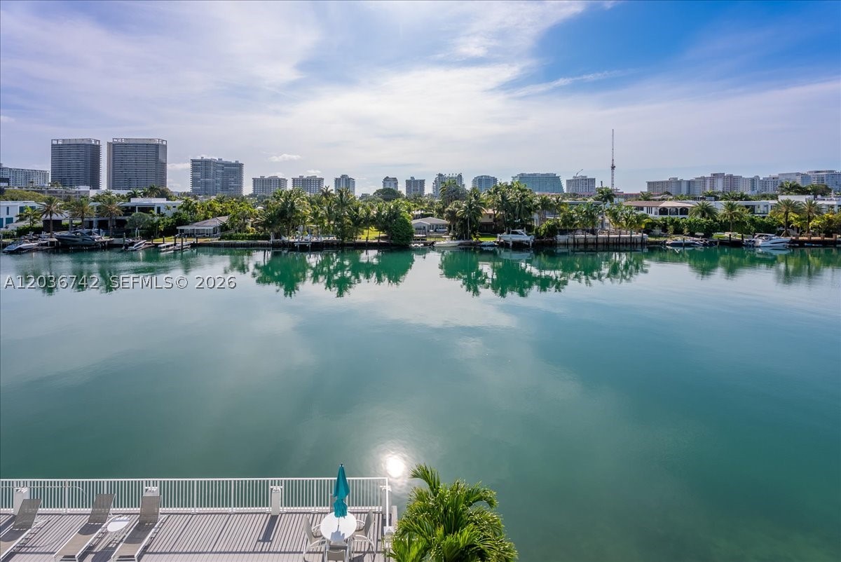 Experience waterfront living at its finest in this beautifully updated 1-bedroom, 1.5-bath residence offering 1,080 SF of bright and inviting living space. Floor-to-ceiling impact windows showcase breathtaking east-facing water views, filling the home with natural light and spectacular sunrises every morning. The residence features high ceilings, elegant tile flooring throughout, and an exceptionally spacious living room layout designed for both comfort and style.

Enjoy serene water views from every room, parking space, and the charm of a boutique waterfront building with a bayside pool, social room, and completed recertifications. Ideally located on the desirable east side of Bay Harbor Islands, just minutes from Bal Harbour Shops, world-class dining, Surfside, and some of South Florida's most beautiful beaches. A rare opportunity to own a waterfront residence in one of Miami's most sought-after neighborhoods. No leasing during the first year of ownership; rental restrictions apply. ::: Amazing balcony