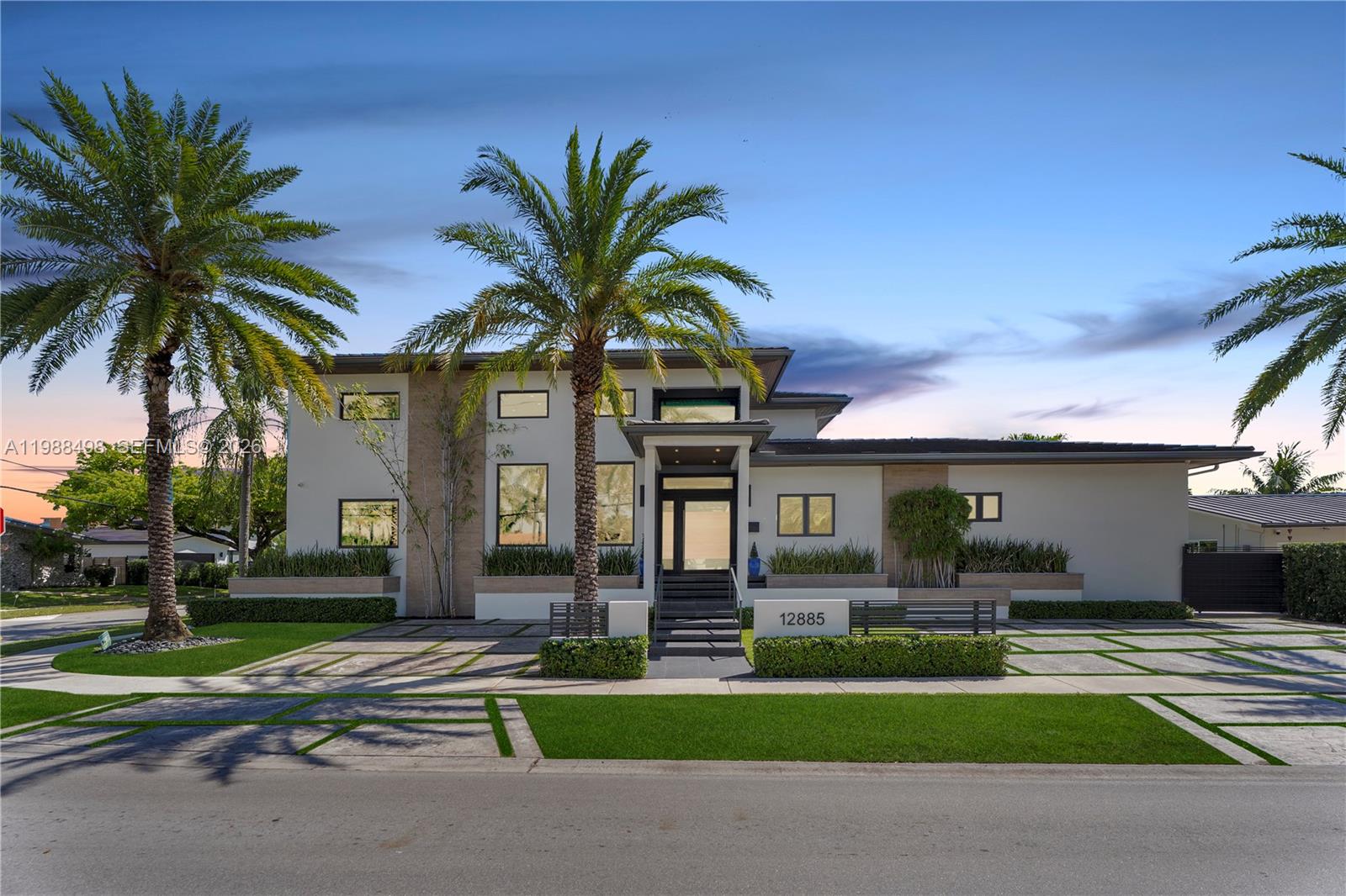 Experience luxury Miami waterfront living in this meticulously custom built residence in the prestigious guard-gated community of Keystone Point. Situated on an oversized 100’ x 125’ corner lot, this exceptional home offers 100' feet of deep-water frontage with direct ocean access and no bridges to bay.  4 bedrooms and 5 designer bathrooms, this home showcases high-end finishes, a grand hurricane-impact pivot entry door, custom solid wood doors, and seamless indoor-outdoor living. The gourmet kitchen boasts natural gas cooking with premium Sub-Zero and Wolf appliances, plus a wet bar with dual beverage dispensers and ice machine. A full smart home system includes integrated audio/video, multi-zone sound, lighting automation, security, cameras, Wi-Fi, pool automation, and more, enhanced by a Bowers & Wilkins and JL Audio system. Additional features include impact windows/doors, copper plumbing, dual recirculating water heaters, an oversized air-conditioned garage (lift-ready), and parking for 11 cars. The corner lot allows easy side access to the garage and dock. Enjoy a private waterfront oasis with a 20K lb boat lift, dock, gazebo with summer kitchen, and lush landscaping. Ideally located just minutes from Bal Harbour, Bay Harbor Islands, and the area’s renowned beaches, this exceptional home offers the perfect combination of luxury, privacy, and convenience.