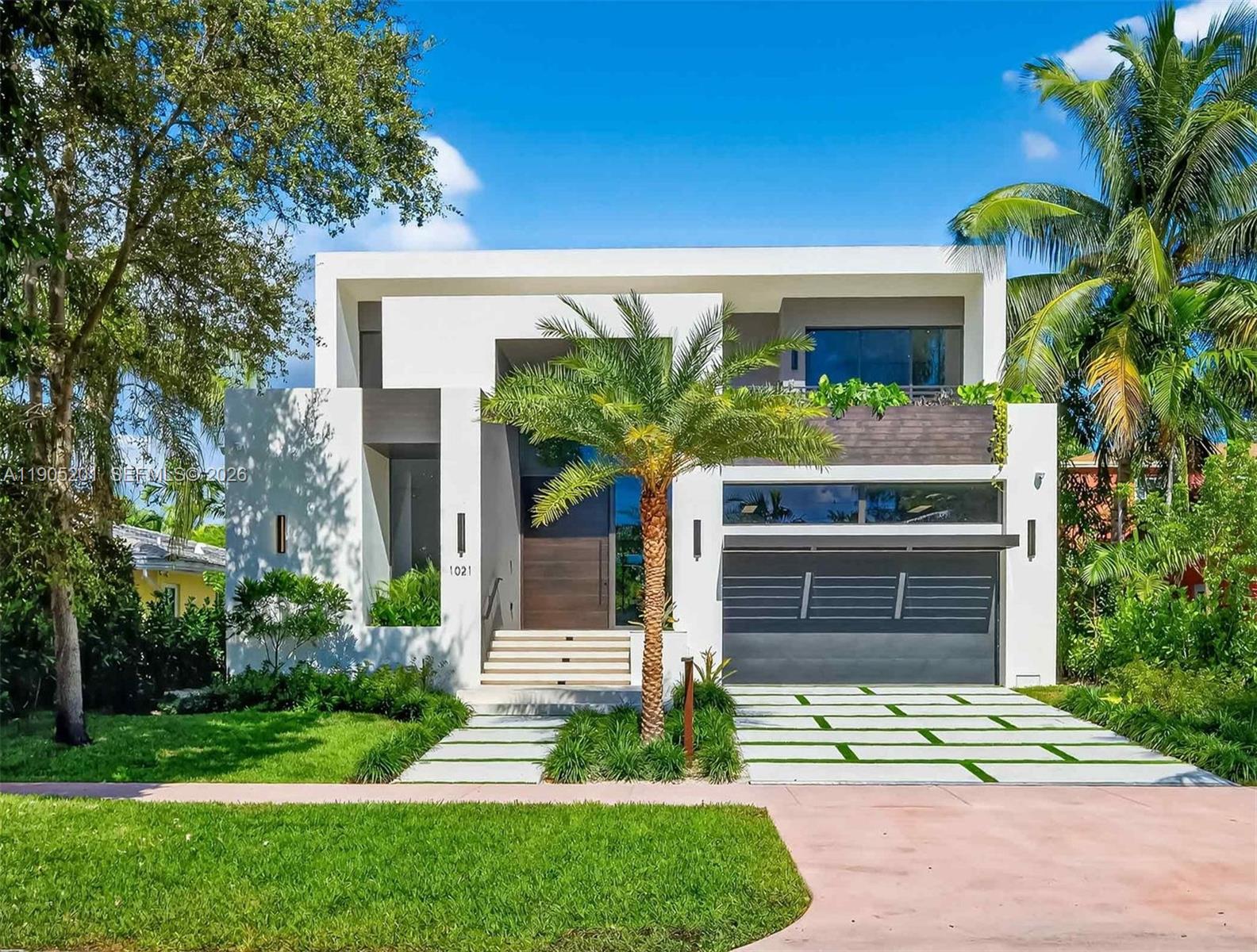 A brand-new two-level modern residence epitomizes the essence of Miami Beach living.
Situated on a 7,500 sq ft lot, 3,750 sq ft under air (4,552 sq ft adjusted), featuring 5 bedrooms and 6 full designer bathrooms. 
Step inside through impact glass doors and windows into high ceilings, expansive living areas, and an indoor-outdoor flow. 
The open kitchen with top-of-the-line Miele appliances, dual kitchen sinks, wine cooler, and bespoke cabinetry.
Spa-style pool, surrounded by tropical landscaping view from each bedroom balcony and an open terrace with an outdoor kitchen.
This smart home integrates an automation system, controlling audio, lighting, climate, and CCTV security. A two-car covered garage adds convenience while maintaining the sleek architectural profile.