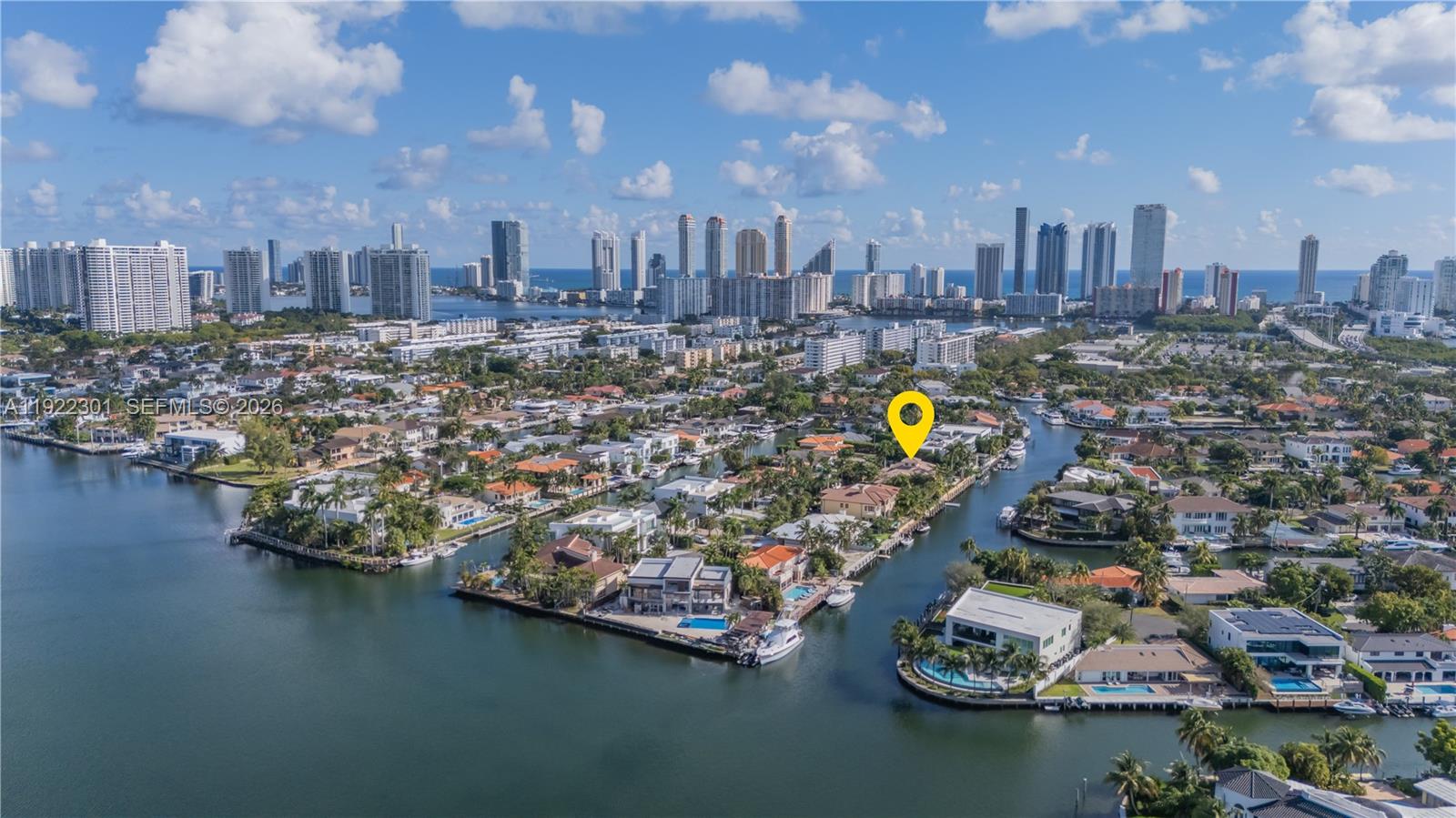 Rare opportunity to own a yacht-ready waterfront estate on two oversized deep-water lots with 160 feet of waterfrontage and a 140-foot private dock featuring a large boat hoist and room for floating docks, jet skis, and additional watercraft. Offering direct Intracoastal and ocean access with no fixed bridges to Haulover Inlet, this property is ideal for large yachts and serious boating enthusiasts.
This expansive one-story estate home is designed for luxury indoor-outdoor living with soaring ceilings, a flexible split floor plan, and sun-filled living spaces that open seamlessly to the resort-style pool, tropical patio, and South-facing waterfront views. The home features 4+ bedrooms with flexibility for additional guest suites, office, gym, or media room, along with a spacious primary retreat with dual walk-in closets, eat-in chef’s kitchen, wet bar, formal dining room and 4 car garage. 
Located in an exclusive 24-hour guard-gated waterfront community just minutes from beaches, fine dining, entertainment, world-class shopping at Bal Harbour Shops and Aventura Mall, and outdoor recreation at Oleta River State Park, this trophy property delivers the ultimate South Florida boating and waterfront lifestyle.