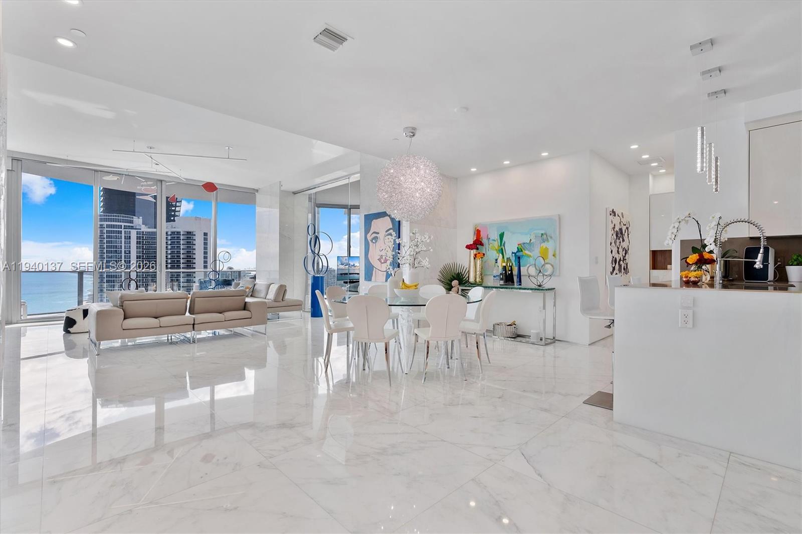 Incredible protected views from this spacious 25th floor 2 bed + Den condo in the heart of Sunny Isles Beach. 11ft high ceilings 3 marble bathrooms, Wind protected balcony, Maids room with full bathroom and service entrance, 3’ x 3’ white marble floors and columns, Luxury master suite with interior glass walls. 29’ of glass in living room, Electric window treatments, Stunning Ocean, City and Park views! Designer unit! Feels a lot bigger inside than the Sq Ft shown. Must be seen! Chateau Beach is a quiet, elegant, exclusive building offering luxury & lifestyle w/ 5 Star amenities including a relaxation room w/ aromatherapy jacuzzi, Beach & Pool towel and food service, cigar room, home theatre, wine lounge, Breakfast bar, full time Concierge desk and much more.