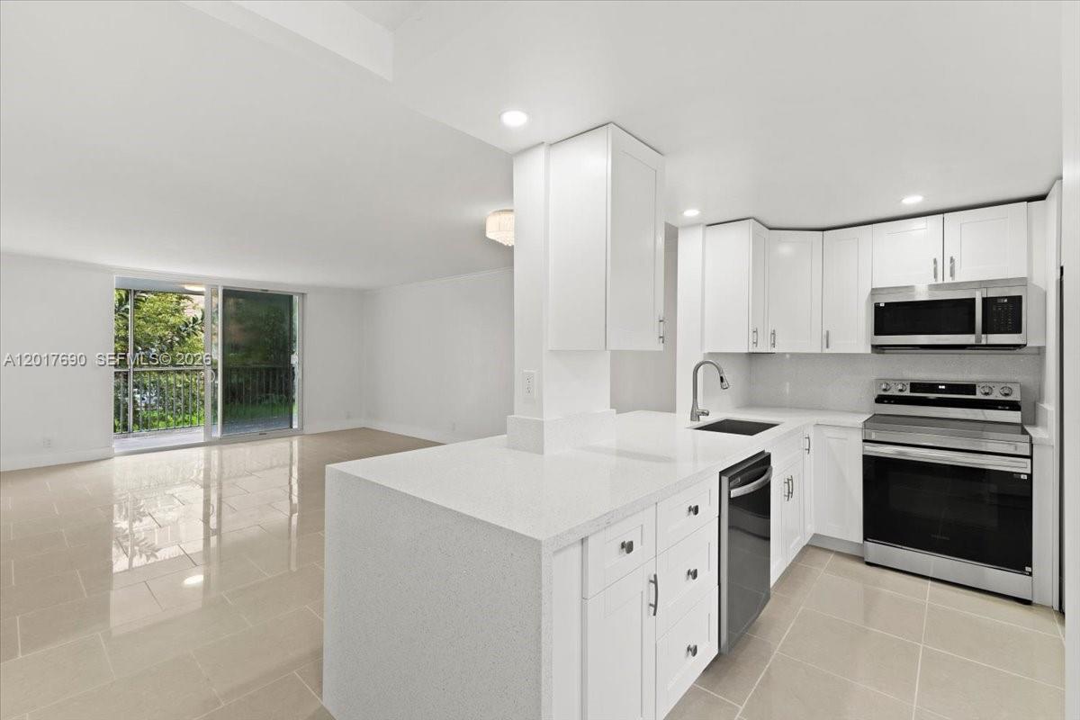 Beautifully remodeled and move-in ready 2-bedroom, 2-bath corner condo located in one of the most desirable buildings in the Meadowbrook community of Hallandale Beach. This bright and spacious residence features hurricane-impact windows and sliding doors, abundant natural light, tile flooring throughout, and a modern open-concept layout with a stylish kitchen showcasing quartz countertops and brand-new appliances. The updated bathrooms feature elegant finishes and illuminated mirrors, while the generously sized bedrooms offer ample closet space. Enjoy a private enclosed balcony overlooking the peaceful courtyard, perfect for relaxing and embracing the South Florida lifestyle. The building has been recently upgraded with a new roof  and new elevator. Amenities include a pool,  BBQ area, and guest parking. Ideally located just minutes from the beach, Aventura Mall, Gulfstream Park, shopping, dining, and Fort Lauderdale-Hollywood International Airport, this property is ideal as a primary residence, vacation home, or investment opportunity. All ages community with rentals allowed after one year of ownership. Se habla español.