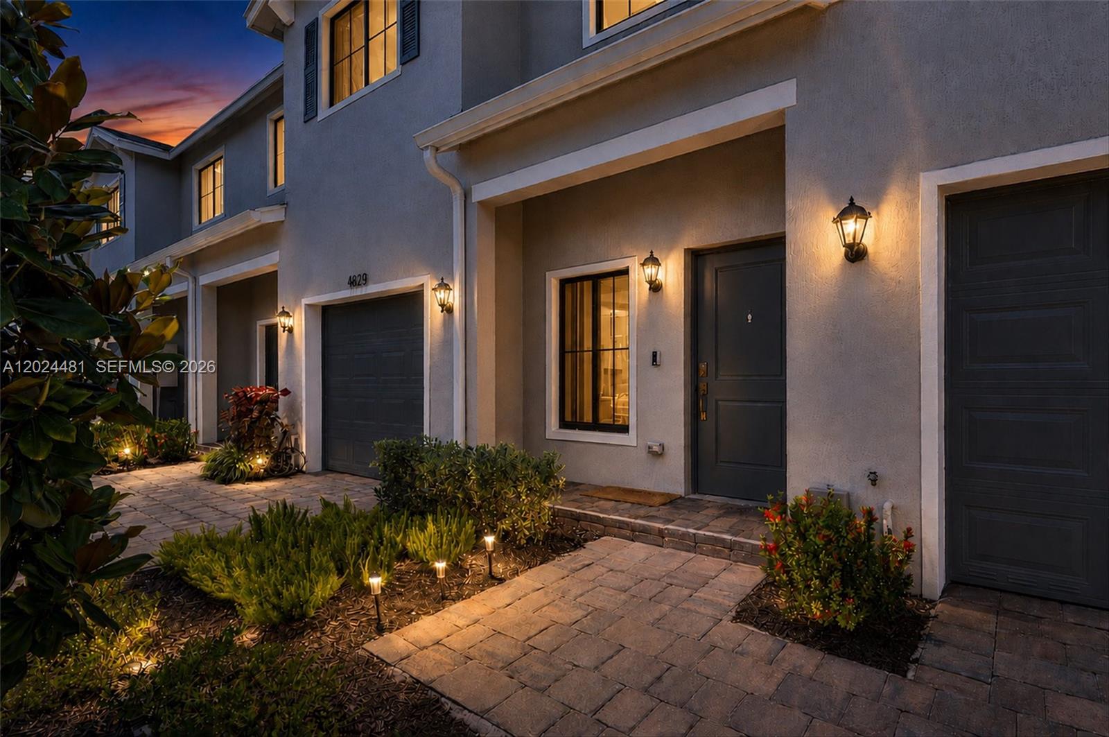 Welcome to this beautifully designed townhome in Ashwood Cove, a newly-built boutique community in Lake Worth. Offering 4 bedrooms and 3 full bathrooms, including a convenient first-floor bedroom and full bath ideal for guests, multi-generational living, or a home office, this modern residence features a bright open-concept layout filled with natural light. The stylish kitchen showcases white quartz countertops, shaker cabinetry, stainless steel Whirlpool appliances, and an oversized peninsula overlooking the dining and backyard areas. Enjoy a semi-fenced private backyard, impact windows throughout, smart home technology, tile flooring on the main level, walk-in closets, tankless water heater, and a 1-car garage plus additional driveway parking for one car. Conveniently located with easy access to I-95, Florida Turnpike, shopping, dining, parks, and beaches, while offering the peace of mind and efficiency of newer-construction living with a low HOA. Assumable 5.7% interest loan option available, contingent on lender's approval of buyer.