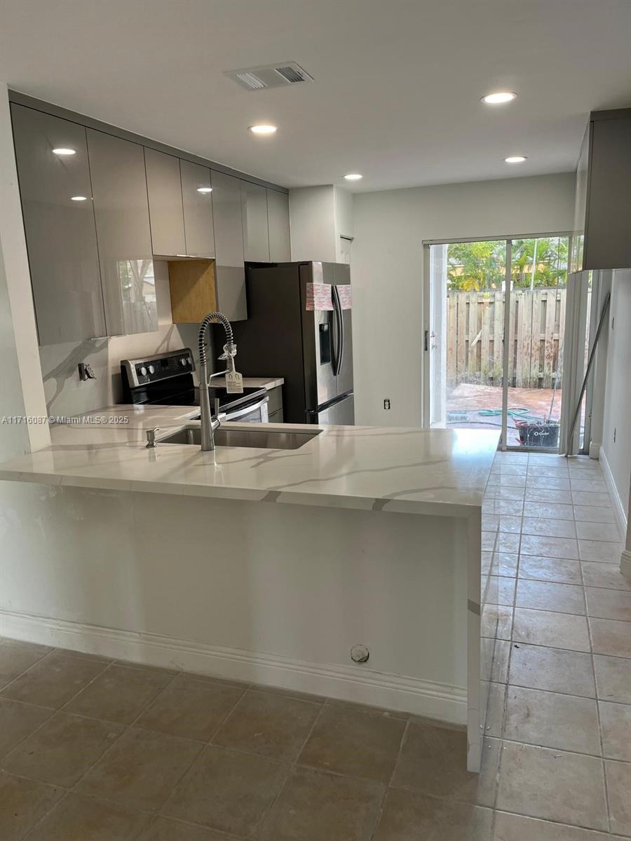 Enjoy this spacious townhouse located in Lago Mar, It has 2 master bedrooms , 2 1/2 bathrooms, remodeled kitchen. It also has one car garage and two additional parking spaces in the driveway. Excellent community. New refrigerator, new microwave, A/c unit.