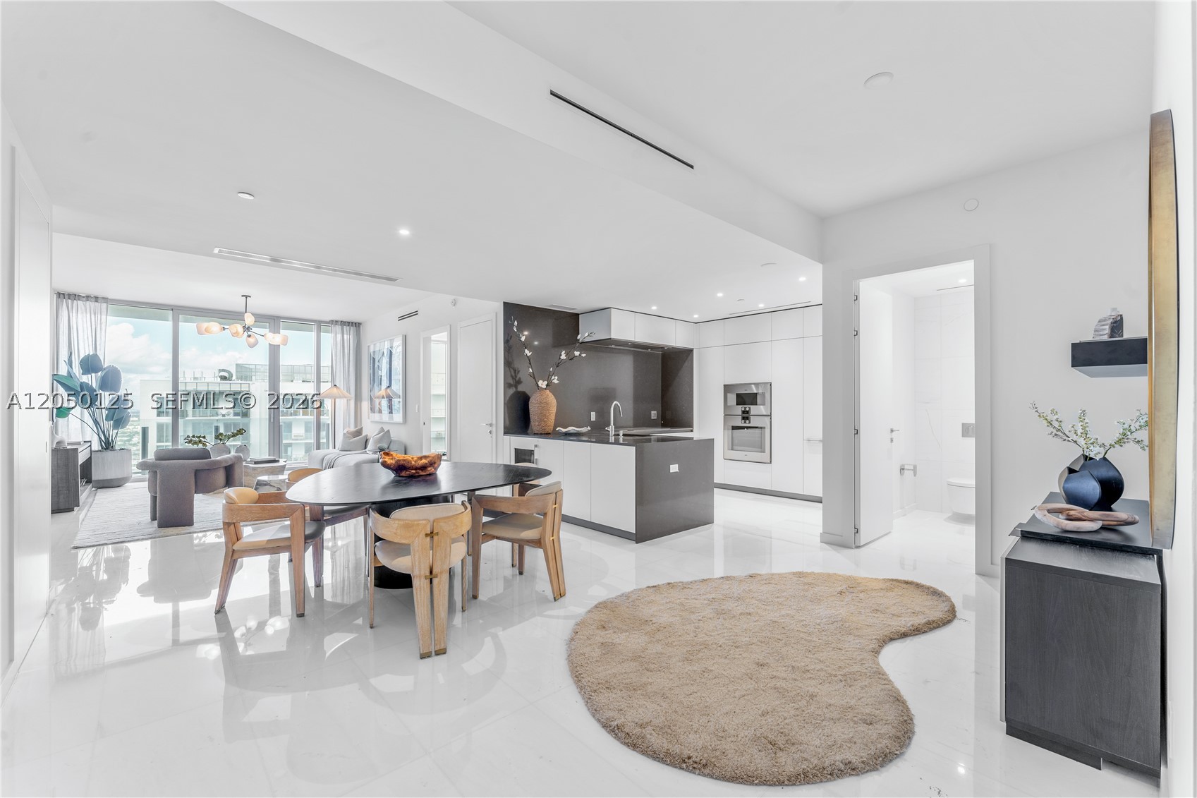 Turnkey, professionally-designed 2 bed 2.5 baths residence in Miami’s premier luxury address: The Aston Martin Residences. A coveted Panoramic Residence and one of the best 2 bedroom floor plans in the building, an open great room and split layout provide ample space for living, dining & an office while 10ft floor-to-ceiling glass provide beautiful city views from every room. The open kitchen is equipped with top-of-the-line Gaggenau appliances, Bulthaup cabinetry and a spacious island for culinary enthusiasts while the primary retreat connects to an oversized en-suite bath with Aston Martin's signature soaking tub and rain shower. Additional features include: guest bedroom with private en-suite bath, front-load washer & dryer, custom window treatments, closets & built-ins and semi-private elevator access. Aston Martin places residents within the best location in the city with world-class restaurants like Zuma and Novikov on the same block and designer shopping at Brickell City Center just across the bridge. The building’s services and collection of amenities are unmatched spanning 4 floors and including indoor & outdoor pools, access to a private beach club, 2-story state-of-the-art gym, men’s & women’s spa facilities, a golf lounge, house car service, and so much more.