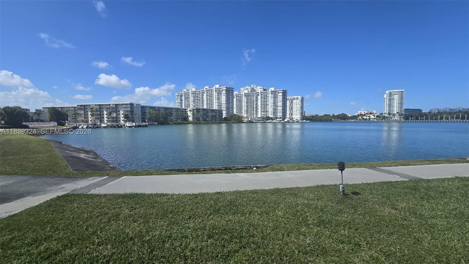 Enjoy stunning bay and marina views from this spacious 2BR/1BA condo in the sought-after Point East 55+ gated community in Aventura. This first-floor unit offers 960 sq. ft. of bright living space with easy access and plenty of natural light. Relax by the water on scenic walking paths or take advantage of resort-style amenities: multiple pools, gym, clubhouse, theater, billiards, library, and courtesy bus. Point East also offers 24-hr security and waterfront picnic areas. Perfectly located near Aventura Mall, Gulfstream Park, beaches, dining, and highways, this condo is ideal as a primary home or seasonal retreat. Experience comfort, convenience, and breathtaking views in one of Aventura’s most desirable communities!, EASY TO SHOW! all offers are WELCOME!