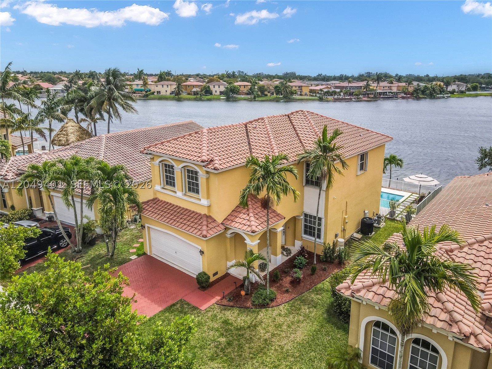 Welcome home to this stunning Lakefront Pool Home! 4BR 2.5 BATH residence located in the highly sought-after community of Vizcaya. Situated on a quiet cul-de-sac with no front-facing neighbors, this home offers a rare combination of privacy and serenity. As you enter, you are immediately welcomed by breathtaking panoramic lake and pool views creating a peaceful ambiance. The backyard features a resort-style saltwater pool (2020) with Jandy® Automation System & premium heating capabilities, allowing for effortless enjoyment and comfort year-round; remote-controlled lighting and expansive travertine pool deck designed for elevated outdoor living; Natural Lighting Throughout, oversized master bedroom with a deep closet and an elegant walk-in dual shower. Contemporary light fixtures, ceiling fans and thoughtful enhancements all throughout the home. Security cameras convey with the property and are equipped for convenient setup. Modern LG appliances, newer washer and dryer, A/C system with UV light and Reme-Halo Guardian air purification system, brand new water heater (2026), and a well-maintained roof. Beyond the home, Vizcaya offers an exceptional lifestyle with a 24-hour guard-gated entrance, 22,000 sqft clubhouse, resort-style pool, fitness center, playground, walking & biking trails. Conveniently located near I-75, the Florida Turnpike, premier shopping, dining, airports, and top-rated schools making this home the perfect blend of luxury, comfort and convenience.