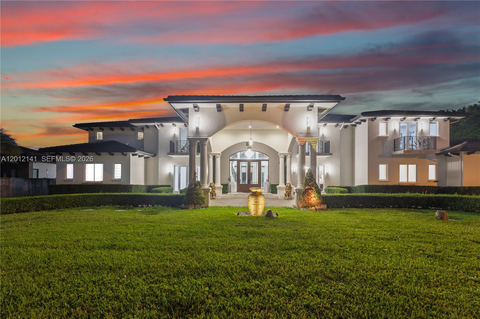 A secluded, gated estate in the heart of Horse Country, this nearly 2-acre property blends architectural artistry with resort-level living. Behind custom wooden doors, soaring ceilings and walls of impact glass set the tone for a home designed around light, scale, and connection to nature.
    With 12,804+ SF, the residence offers 8 bedrooms, 9 full bathrooms, 2 (1/2) baths, an elevator, dual staircases, and expansive terraces off every room. The chef’s kitchen centers around a dramatic marble island and is complemented by multiple midnight bars and a full outdoor kitchen.
    The first level includes two bedrooms, two offices, a children’s playroom/study area, theatre, and gym. Upstairs, six bedrooms and a private family room. The grand primary suite with dual walk-in closets, spa bath, and steam sauna. Outdoors, lush grounds surround an infinity saltwater pool with jacuzzi, waterfall, summer kitchen, and a full outdoor bathroom. The property is lined with an extraordinary collection of fruit trees—mango, soursop, avocado, dragon fruit, plantains, mamey, and more.
   Additional features include washers/dryers on both floors, a 3-car garage, ample parking, security system, and a newer flat tile roof.