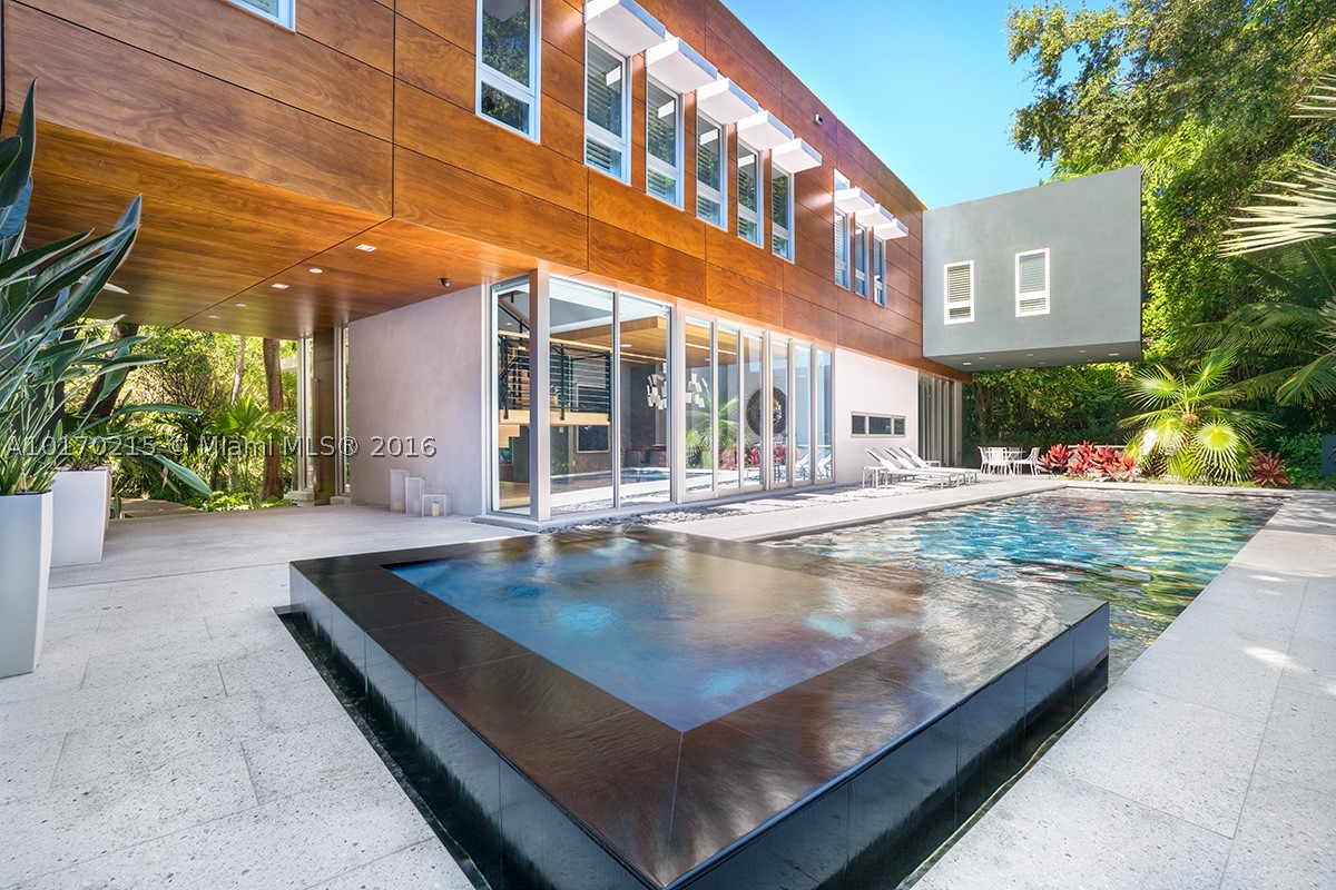 Hammock House is a truly-unique modern 6,212 sq/ft home situated on a lush tropical hammock in exclusive gated Camp Biscayne in Coconut Grove. This 6 bed/7.5 bath home boasts 36in. marble flooring/baseboards, Boffi kitchen w/Miele & Sub-Zero appliances & staff quarters. Open living spaces naturally flow through glass walls to outdoor entertainer's dream w/heated salt-water pool, Jacuzzi, & summer kitchen amid park-like landscaping. Control4 home automation w/Lutron lighting, video security & generator.