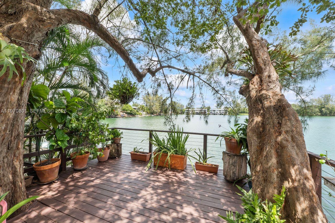 Enjoy unbelievable water views from your own private deck in this serene, nature-focused community of Lakeridge - a “hidden gem” townhome community in unincorporated Miami-Dade, close to South Miami, Coral Gables, and Westchester. This elegant 3BD/2.5BA two-story townhome offers almost 2,000 SqFt living area, massive living room, formal dining, and large open kitchen with ample storage and a breakfast nook. Other highlights include beautiful wood floors, impact windows and doors, newer metal roof (2022), tankless water heater, gated patio entry, and inviting wooden deck overlooking the beautiful lake. Recent updates include water infiltration system throughout, new carpet upstairs, and freshly painted interiors. The community offers incredible amenities including two pools, hot tub, tennis courts, walking trail, beautiful lush landscaping, children’s play areas, a butterfly garden, guard gate, and of course the 22-acre lake. This is a truly unique property that you would not expect to find in the heart of Miami – a spacious, updated townhome in a tropical lakefront oasis.