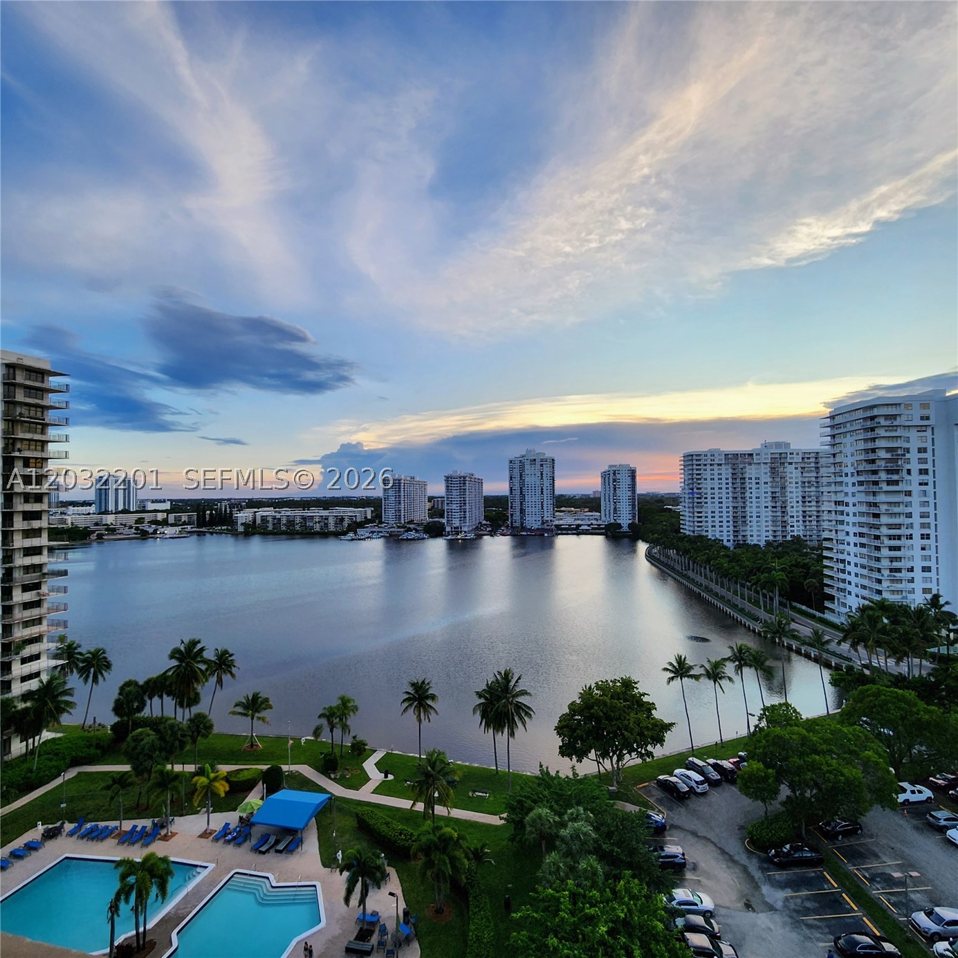 Floor to ceiling windows offer stunning lake, skyline, & sunset views. Clean, spacious rooms with lots of natural light. Lovely laminate floors throughout. Can include furniture – Buyer option. Ample closets, extra storage, covered parking. Excellent Biscayne Cove Tower in vibrant Aventura. Current 40-year reno work includes glass balcony railing, new impact windows/slider. Fab schools Aventura Charter or Waterways K-8/Krop. Pet friendly, max 20 lbs. 24/7 guard gated security, valet, gracious attended lobby, 2 pools (1 heated), hot tub, fitness center, yoga/media/game rooms+. Lit tennis, racquetball, basketball courts now under construction. Maintenance includes enhanced basic cable, water, pest control+. As is, inspection welcome. Minutes from beach, world class shops & dining, Aventura Mall, Bal Harbour, Gulfstream, entertainment, airports.