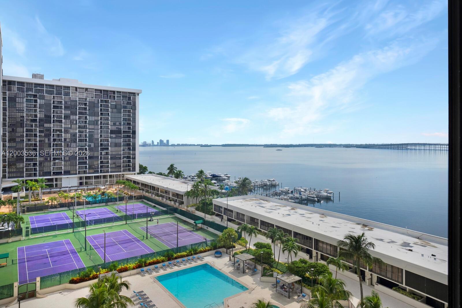 Live on Brickell Avenue's quiet side, and enjoy breathtaking Biscayne Bay views from this renovated one-bedroom, 1-1/2 bath 10th floor Brickell Place unit with 1,005 sq. ft. of interior living plus a substantial balcony. The unit has an assigned storage space in the building and one covered assigned parking space.  Brickell Place offers security and privacy, with lots of amenities such as six tennis courts, indoor racquetball courts, two pools, a billiards room, a state-of-the-art gym, a BBQ area, a bay walkway, and an on-site marina.  A security-guard gate provides access to the complex, with guest parking available.  The 40-year recertification has been completed. Seller to pay special assessment balance prior to closing.