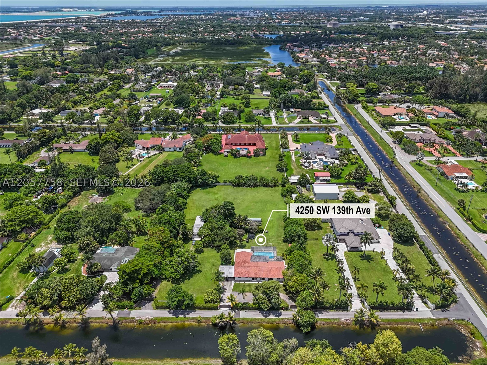 Private 2.28-Acre Ranch Retreat in Exclusive Country Club Ranches Estates! Experience unmatched privacy, open space, and natural beauty in this extraordinary estate. Set on sprawling grounds, this property features a 4-bedroom, 3-bathroom main residence, barrel roof, driveway entrance, ceramic floors throughout the residence and exceptional outdoor living. The spectacular backyard is a true sanctuary with mature mango and avocado trees, peaceful green spaces, your own private soccer field, an entertainment deck perfect for outdoor dining and BBQs, and a stunning oversized saltwater pool for resort-style living. A rare lifestyle property where privacy, recreation, and convenience come together, just minutes from city conveniences, major highways, shopping, dining, and excellent schools. No HOA fees. Recently connected to city water!