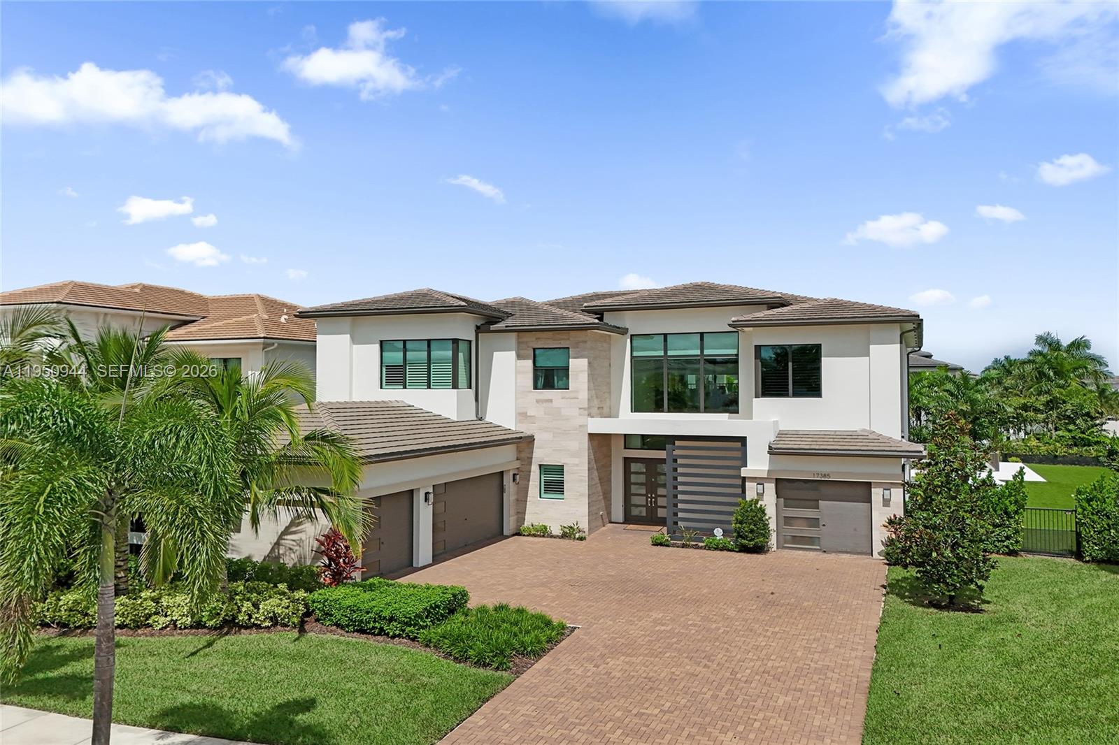 17385 Ponte Chiasso Drive is located in one of the most desired neighborhoods in Boca Raton offering state of the art clubhouse, tennis courts, pickleball courts, playground, resort style pool, lap pool, splash pad, indoor/ outdoor restaurant, gym, indoor & outdoor basketball courts, walking trails and more. Built in 2022, this custom built estate offers over 6000 sq ft of unparalleled living space located on an exceptional 0.47 acre corner lot including 5 bedrooms, 7.5 bathrooms, Media room/ optional 6th bedroom, club room/ optional 7th bedroom, loft and 4 car garage. The homesite features fully custom interior upgrades, including a thoughtfully laid out custom kitchen designed with high end appliances, double waterfall islands, Taj mahal custom stove hood, millwork, custom cabinetry throughout, custom finished closets, epoxy finished garages, resort style custom salt water pool and fully turfed backyard with privacy from all sides. All bathrooms, plumbing and mirrors inside the home have also been custom finished.  No detail was spared when designing this home. Additional details of upgrades available upon request.