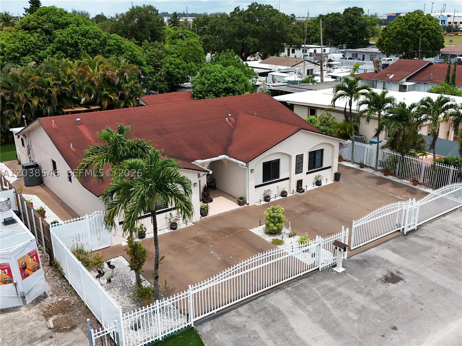 No HOA & No Flood Zone!!  Beautiful & Impeccable 1-story home with amazing income producing investment potential.   Main house is a 4/2 with a split layout for privacy.  Separate 1/1 with private entrance as guest house, In-law quarters or rental income with kitchen & bathroom.  Plus, 1 addtl. room also with private entrance, bath & split A/C for studio, office, gym, indoor storage, guest or room for rent for a total of 6 bedr. and 4 baths.  Window coverings of modern zebra-style blinds provide natural light.  Upgraded kitchen, nice cabinetry, wine cooler and a huge mobile island with snack counter perfect for entertaining.  Hurricane season protection with impact-resistant glass windows & doors, tiled flooring, attic with electricity, indoor laundry, roof (2012), rain gutters, concrete driveway, plenty of space to park 7-8 Cars, RV or Boat, dual side-entry access and gate in front.  Family fun and unforgettable memories are waiting for you in this gorgeous home with a relaxing covered terrace, fenced patio, large backyard with artificial turf for free maintenance, spectacular outdoor kitchen with a gas range, sink, small microwave and refrigerator for cooking under the stars.  Space for a future pool.  A storage shed with electricity & fan (130 sqft).   Septic Tank serviced (2025).  Minutes from Miami Dade College North Campus, Miami Airport, Little River Park & Amelia Earhart Park with soccer, dog park, water sports, trails & aquatic water park.  Call me for a private tour.
