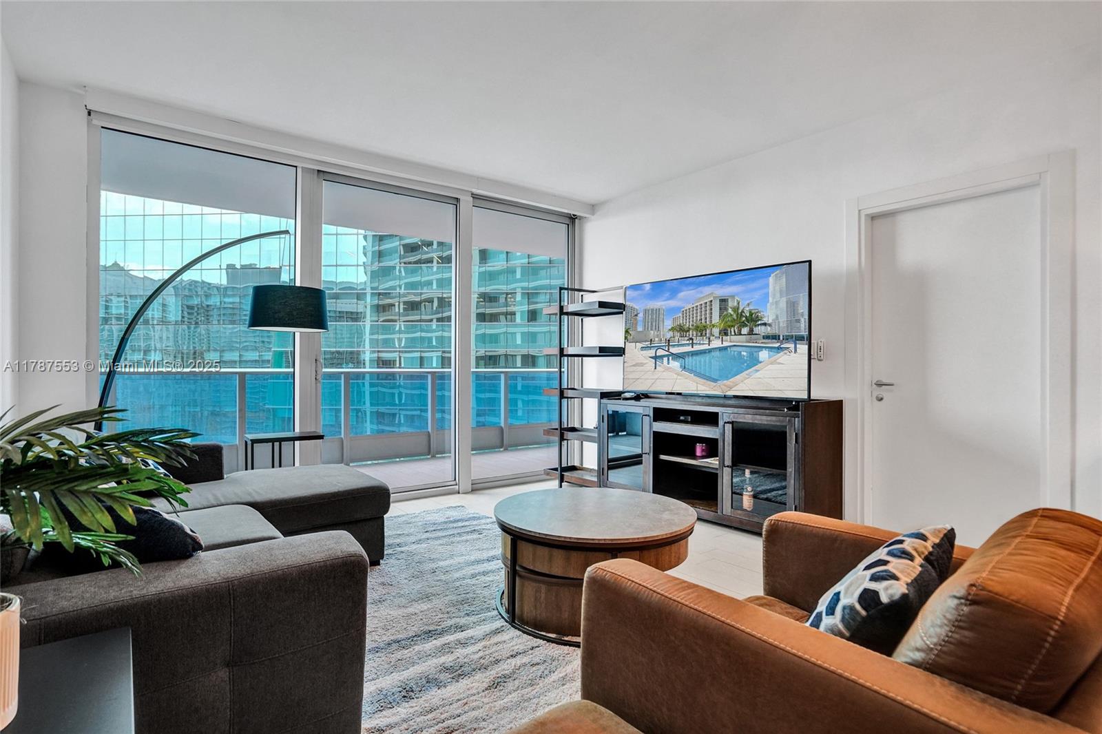 Step into refined elegance at Epic Residences with this stunning 1-bedroom, 1.5-bathroom condo on the 32nd floor. Spanning 822 sqft, this fully furnished home boasts a sleek, modern design with floor-to-ceiling windows that frame panoramic views of the Miami River, Biscayne Bay, and the vibrant city skyline. The kitchen is equipped with top-tier Miele and Sub-Zero appliances, custom Italian cabinetry, and quartz countertops, perfect for culinary enthusiasts. Enjoy the convenience of motorized shades, high-end finishes, and a spacious balcony ideal for soaking in the breathtaking views. Residents of Epic Residences indulge in world-class amenities, including a private pool, state-of-the-art fitness center, spa, and exclusive access to renowned on-site dining options. Don't miss this!!
