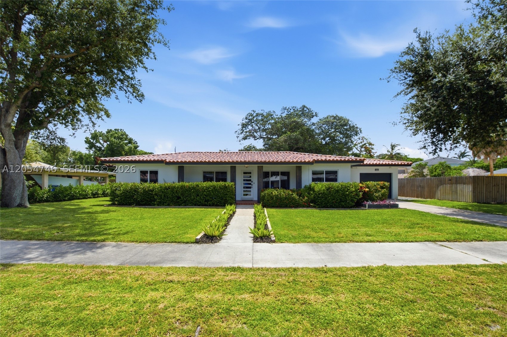 Completely renovated 3-bedroom, 2-bath pool home situated on an oversized triple lot in the desirable Old Pompano neighborhood! This move-in-ready home features a designer kitchen with soft-close cabinetry, oversized island, quartz countertops, and full-height backsplash. Bathrooms have been beautifully remodeled with modern finishes and frameless glass shower doors. Renovations include new flooring throughout, updated electrical and plumbing in renovated areas, a tankless water heater, and all impact windows and front entry door. Enjoy true South Florida living with a heated pool, outdoor hot/cold shower, approximately 1,000 SF of new wood decking, a custom-built BBQ island, and an impressive 18’x20’ insulated aluminum pergola with LED lighting and dual ceiling fans. Lush tropical landscaping, privacy hedges, and landscape lighting create a private backyard oasis. The property includes three 50’ lots, with the third separately fenced and prepared with lime rock, water, and electric—ideal for RV, boat, or trailer storage. The home has passed all inspections and qualifies as an Airbnb. Conveniently located just minutes from the beach, Atlantic Blvd, US-1, shopping, dining, parks, golf, and the exciting Harrah’s Pompano/The Pomp entertainment district.