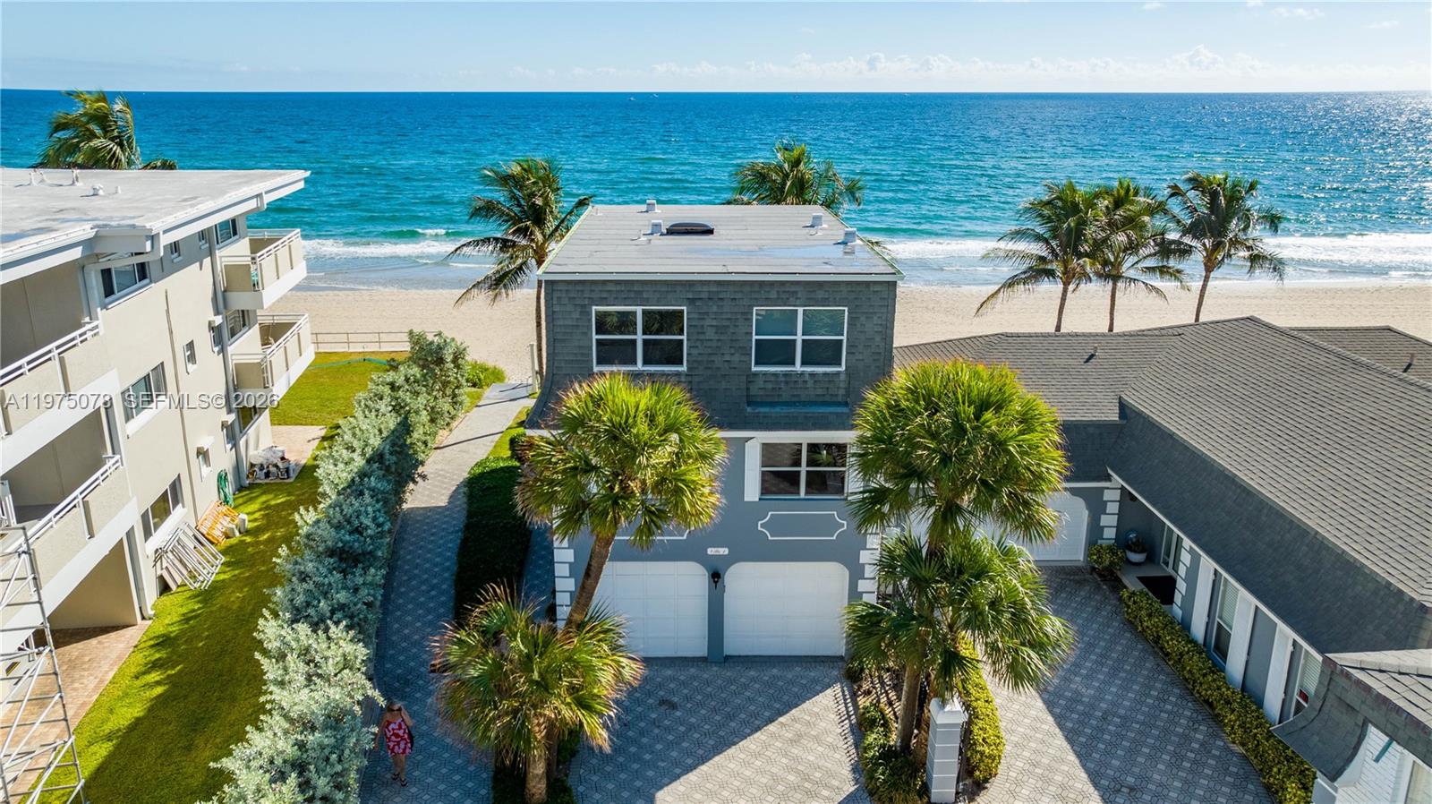 Live the lifestyle everyone dreams of! Breathtaking panoramic ocean views that will make you feel on vacation everyday! This 4 bed /3.5 bath corner beach home is located in the prestigious Hillsboro Beach & Yacht Club & is a very unique opportunity. As you enter you'll find a spacious sitting area with beach view, convenient bedroom with full bath & 1 car garage. Go up to the 2nd floor and a bright area welcomes you including an open European modern kitchen with large island, family room & half bath. Finally the 3rd floor boasts the primary bedroom where you can wake up to the ocean breeze & sound of waves, as well as 2nd & 3rd bedroom with 3rd bathroom. This is a true gem, just step out of the backyard right onto the sand. 1 car garage was converted into the 4th bedroom