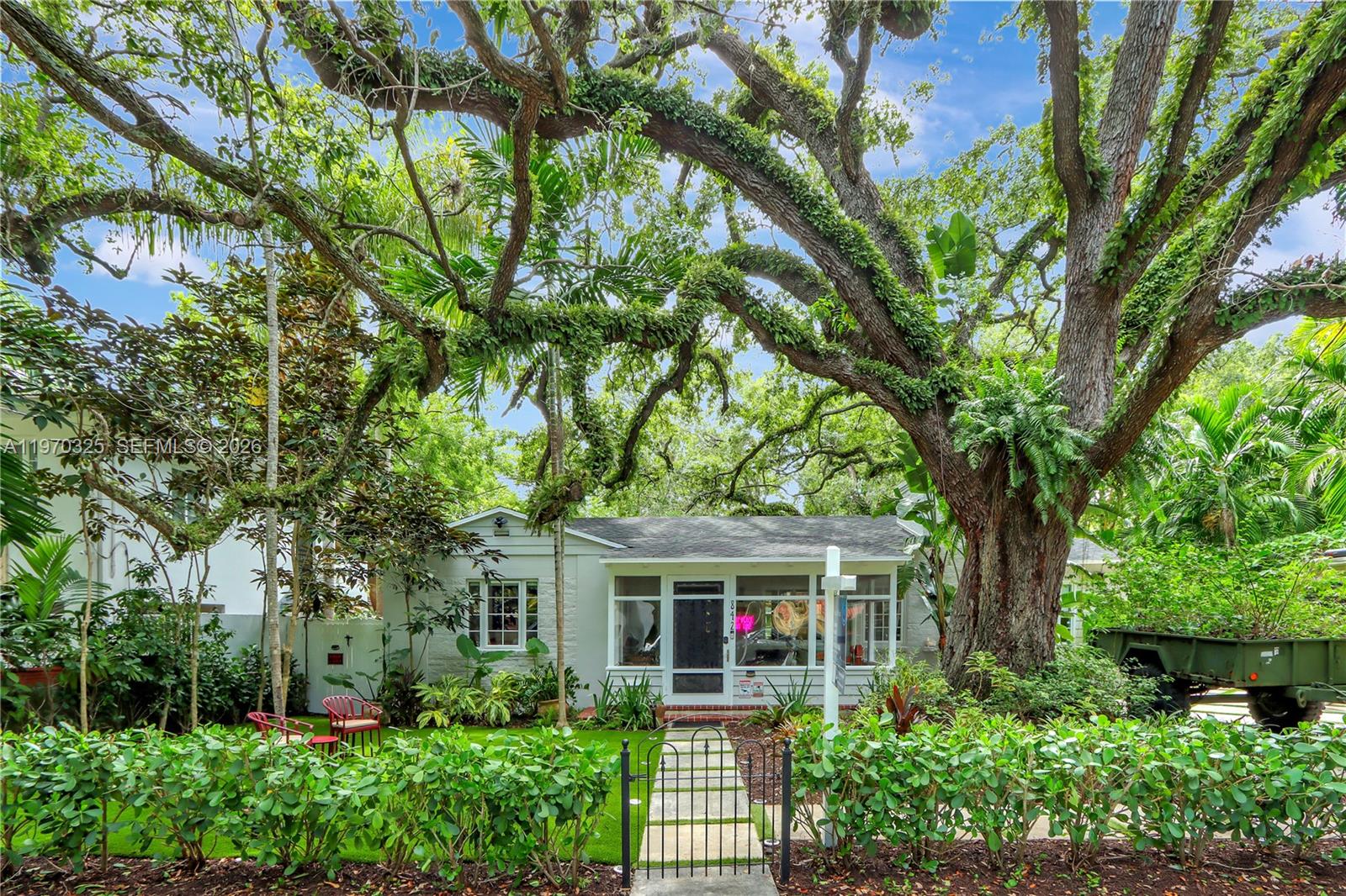 Set within the storybook charm of Miami’s historic Spring Garden neighborhood, this beautifully renovated 4-bedroom, 3-bath residence offers an exceptional lifestyle defined by privacy, character, and effortless convenience—crafted for those who believe only the best will do. Light-filled interiors showcase thoughtful updates throughout, including a contemporary kitchen, impact windows, and a welcoming fireplace that creates a warm, refined ambiance. A detached guest house adds valuable flexibility, perfect for extended stays, a home office, or a creative retreat.
Outdoors, the generous 9,450-square-foot lot feels like a private sanctuary, complete with a spacious entertaining deck, hot tub, and lush greenery that enhance the home’s tranquil setting. Spring Garden is celebrated for its historic significance, majestic tree canopy, and strong sense of community. Opportunities to own a fully updated home in this timeless and centrally located neighborhood are truly rare.