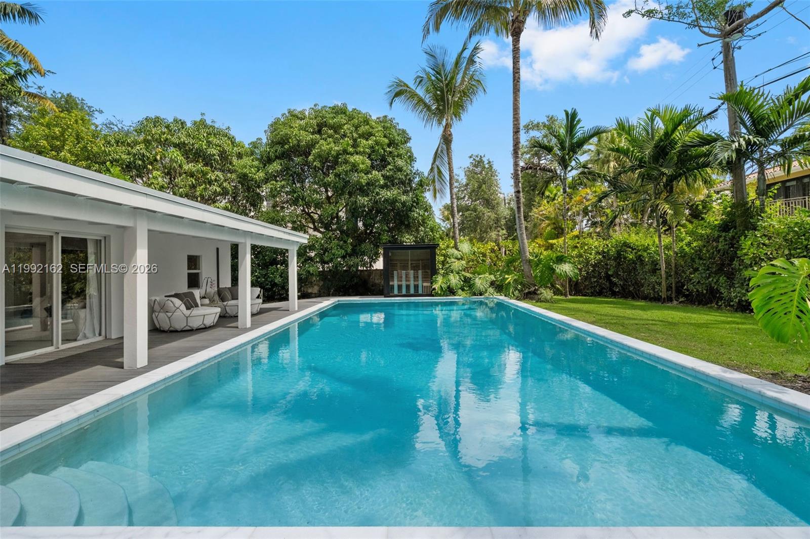 Beautifully reimagined residence in the highly coveted High Pines enclave of South Miami. This single-story home seamlessly blends timeless character with sophisticated modern European enhancements, including fully updated electrical and plumbing systems, high impact windows and doors, and integrated smart home technology with remote-controlled lighting.The designer kitchen showcases custom wood cabinetry and elegant Italian porcelain countertops, opening to light-filled living and dining spaces curated for effortless entertaining. Outdoors, a private tropical retreat awaits, complete with an oversized resort-style pool, infrared sauna, and lush, manicured landscaping. Additional highlights include two primary suites, versatile guest/maid room (5th bedroom), stunning built out closets, covered carport, dedicated storage, and a prime location just moments from premier shopping, dining, and everyday conveniences. Around the corner from Sunset Elementary School. Impeccably updated and truly move-in ready. A Beautiful Miami Home! Make It Rein!