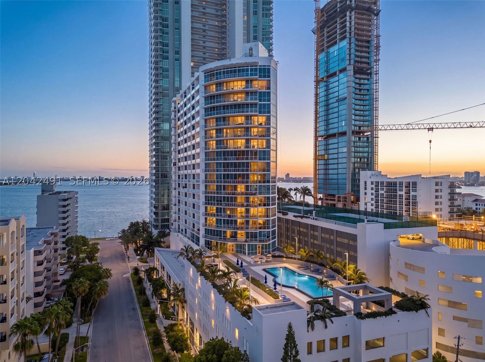 Discover sophisticated waterfront living in the heart of Miami's vibrant Edgewater neighborhood. This spacious largest 2-bedroom floor plan offers an open layout filled with natural light through floor-to-ceiling windows and contemporary finishes. Take in breathtaking Biscayne Bay and city skyline views from the expansive wrap-around balcony, while the primary suite enjoys its own private balcony—perfect for morning coffee or evening sunsets. Residents enjoy newly renovated resort-style amenities, including a heated pool, hot tub, fitness center, sauna, and BBQ area.Ideally situated just minutes from Wynwood, the Miami Design District, Midtown, Downtown Miami, and Miami Beach, this home offers the perfect combination of luxury, comfort, and unbeatable convenience in one of Miami's most desirable neighborhoods.