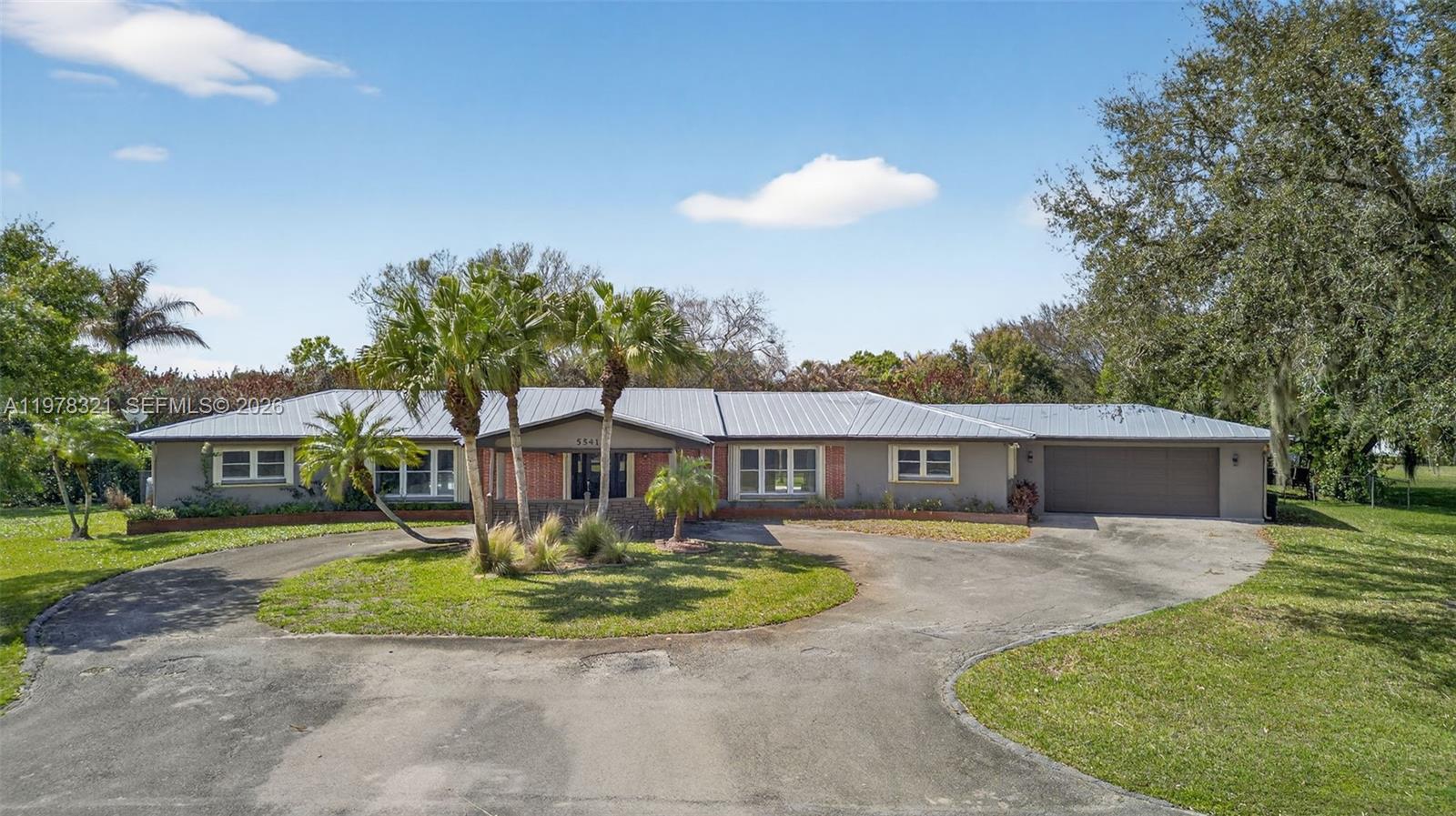 This exceptional 4150 Sq. Ft estate-style home sits on a spacious 0.85-acre lot and has been beautifully renovated throughout. The property features a newer metal roof and accordion shutters, providing both durability and peace of mind. The updated kitchen is designed for both functionality and style, featuring a double oven, contemporary porcelain induction range top, and a premium Sub-Zero refrigerator. Step outside to an elegant pool area with a newly finished stone patio, perfect for entertaining and hosting outdoor gatherings. A major highlight of the property is the solar panel system, which powers the entire home at virtually no cost. The system also supports an 80-gallon hot water heater, improving energy efficiency even further. Additional features include: A private office off the primary bedroom. Updated bathrooms with modern finishes. A circular driveway with a porte cochere, providing ample space for multiple vehicles of any size. SOME Areas are Virtually Staged
