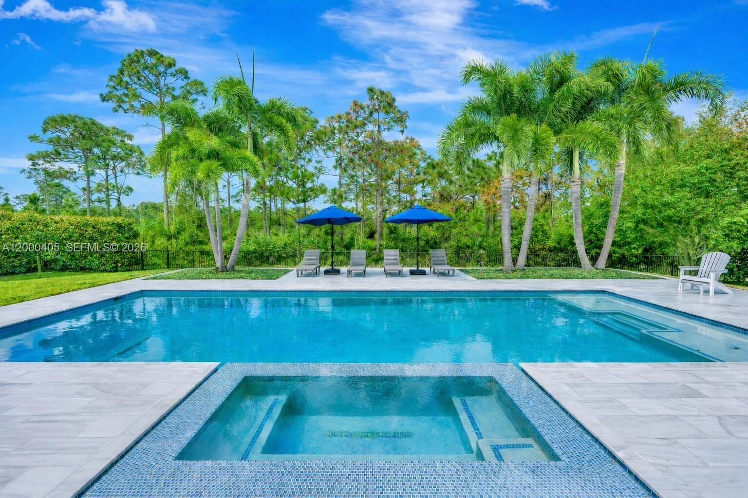 Tucked away in the gated community of Prado, this 2017 CBS, Coastal residence offers space, privacy + the lifestyle Jupiter is known for w/the added convenience of PBI Airport/West Palm Beach less than 30 min away. Gorgeous ¾ acre property w/beautiful resort-style pool + spa overlooking a serene Nature Preserve w/no rear neighbors. Just over 5,000 SF of living space offering 5 bedrooms w/the primary downstairs + dedicated office space + second level loft & large flex space room. The interior reflects an elevated, organic aesthetic w/timeless, architectural details such as warm, neutral wood flooring, tray ceilings, mouldings, and an extended primary suite featuring soaking tub, shower, dual vanities + outfitted his/her closets.The chef's kitchen is equipped w/high-end JennAIR appliances, Induction cooktop, large walk-in pantry, white-wood cabinetry, tile backsplash, gorgeous Quartz counters, island + cozy dining area overlooking the pool. 2nd level features a "Junior Suite" w/updated full bath & large walk-in closet, 2nd laundry room, loft, flex space (media or playroom) +3 balconies to relax + enjoy the sought-after Jupiter lifestyle. Salt chlorinated pool + spa w/ Jandy Aqualink System, marble pavers + custom landscaping, 3 car garage + 8 car motor court, Impact Glass, Dual Zoned Lennox HVAC Systems. Best of both worlds - Privacy + Convenience; Prado homeowners enjoy expansive, private homesites w/parks, schools, golf, beaches, marinas, shopping, dining and more all nearby.