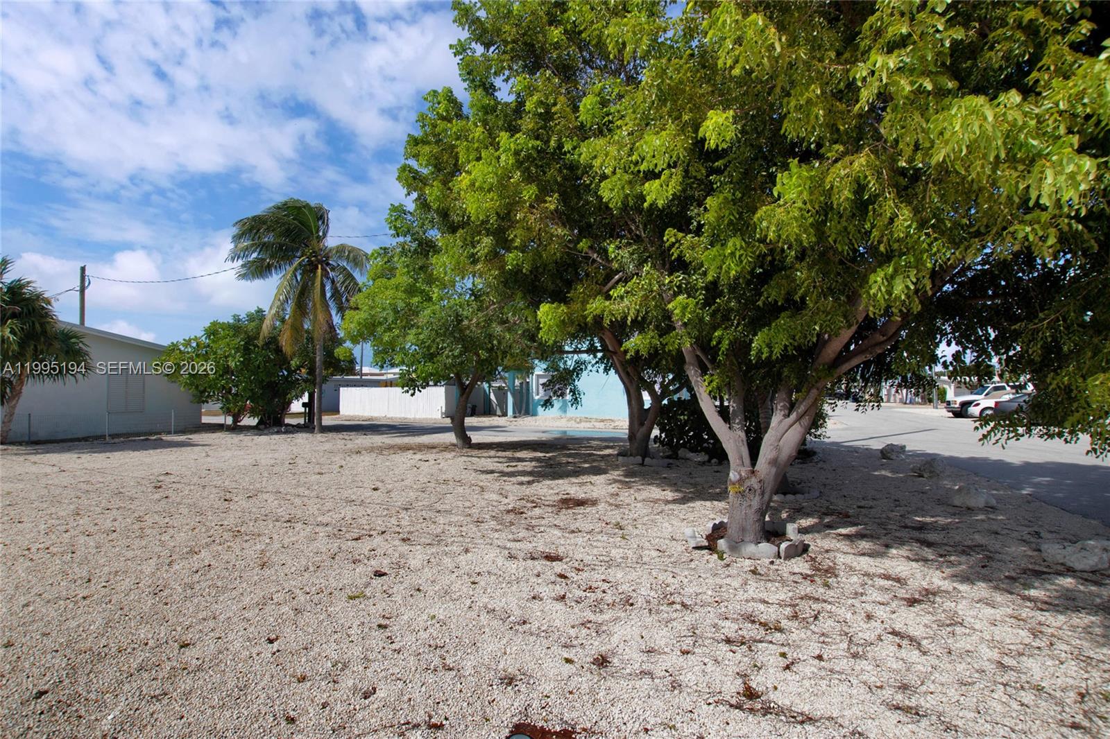 Cleared and Vacant Lot located in the desirable neighborhood of Little Venice AND IN THE ONLY QUALIFIED FEDERAL ECONOMIC OPPORTUNITY ZONE in the FL Keys! Come build your dream home in paradise with possible Ocean views with a stilted home. No need to worry about biological surveys or clearing permits, and the yard is already graveled. Sewer Hook Up ready on street. Adjacent home is also available for sale. Call for additional info on this tax saving/tax credits opportunity. Buy both and have a lot of extra room for privacy or accessory structures.