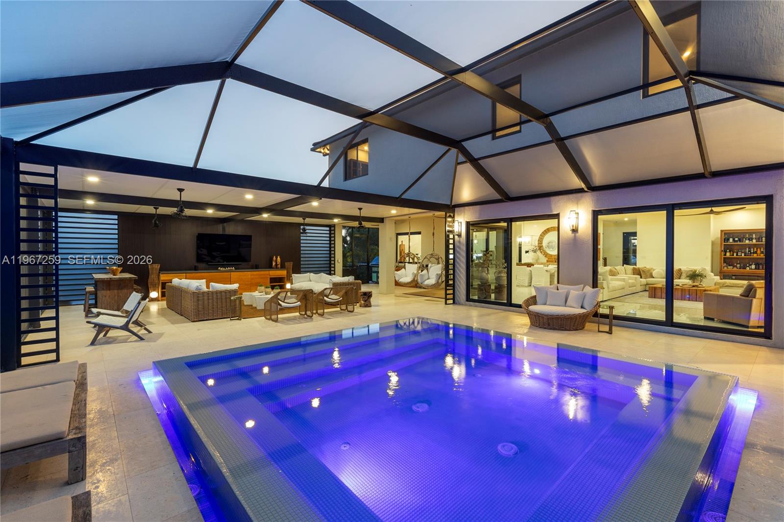 One of one, a showpiece designed for resort-style living 24/7 in one of the only cul de sac in Ave María. 

Offering 3,985 sq ft under air | 5,061 total sq ft | 1,800 sq ft of backyard living, this 4-bedroom + loft - 3 car garage estate blends tropical elegance with modern luxury.

Enter through a covered screened entry and experience seamless indoor-outdoor living with four massive custom impact glass sliding doors opening to a breathtaking 50’ x 30’ covered screened patio with travertine floors.

Interior Features: Porcelain tile downstairs, premium luxury 100% waterproof vinyl floors upstairs, custom maple staircase, Chef’s kitchen with Kitchen Aid double oven, an addition secondary oven, induction cooktop & quartz backsplash from counter to ceiling. Massive 10 x 4 island for great entertainment and your gatherings. Custom pantry & laundry built-ins, Designer half bath with floor-to-ceiling statement wallpaper with resemblance of the Ave María Church wall finish. 
7” gutters & whole-home,  KINETICO water filtration system. Electric Car charger ready. 

Outdoor Oasis: Insulated covered living area + screened enclosure, Arhaus modular summer kitchen with integrated Hestan BBQ, tropical landscape with christmas palms creating total privacy & ambiance. 

Casa Bali is truly one of one — semi-custom built, thoughtfully designed, and unlike anything else on the market.