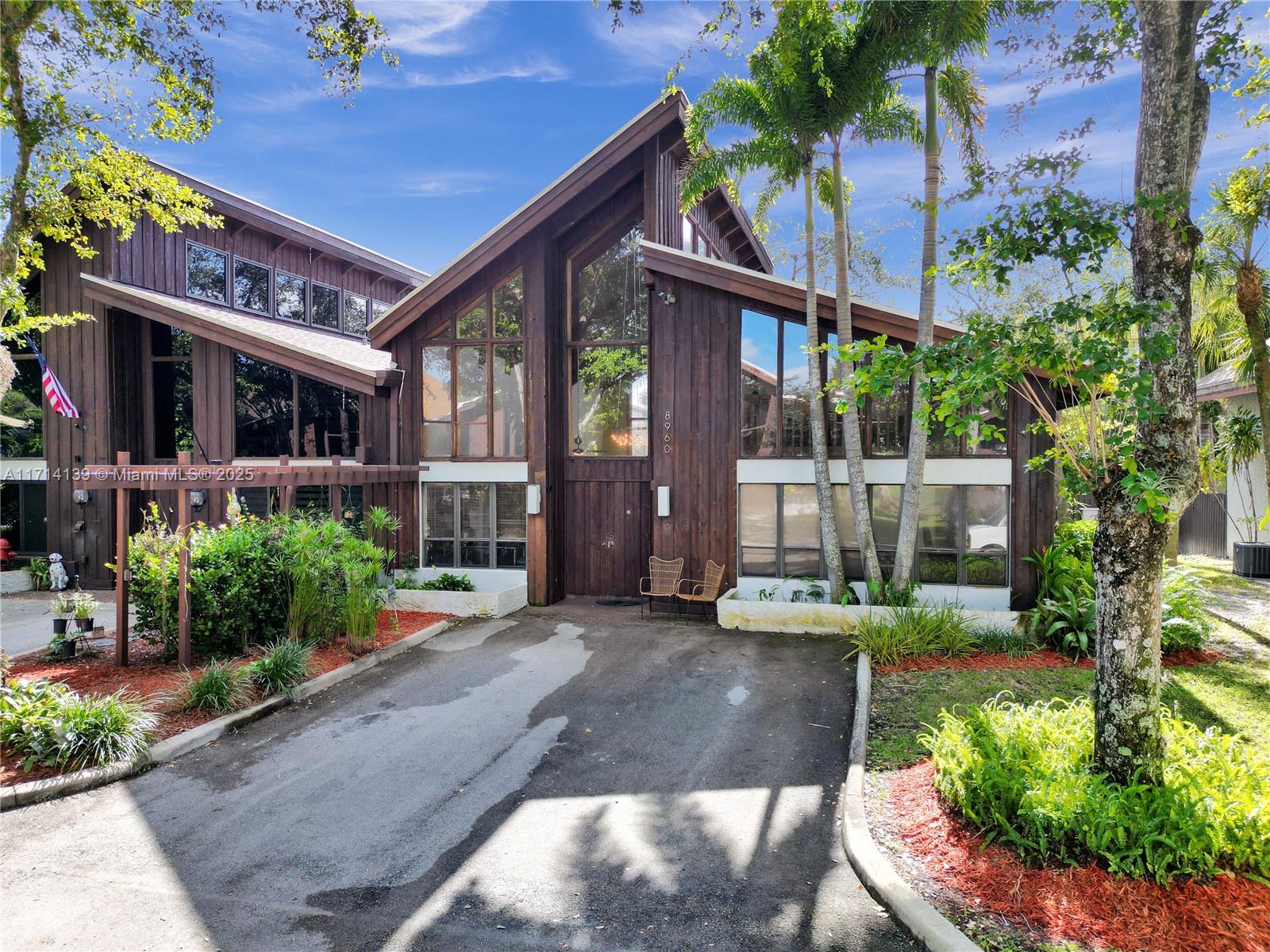 Light and bright, this 3 bed, 2.5 bath chalet style home is waiting for you! Enjoy an open concept floor plan with beautiful 29’ soaring vaulted ceilings, exposed wood beams and natural light in abundance. The owner’s suite with large walk-in closet is located on the 1st floor, along with a guest bedroom and full guest bathroom. The spiral staircase leads up to the 3rd bedroom and 1/2 bathroom. Outside, find a fenced (2024) private deck perfect for lounging or enjoy the community pool just steps away. Your comfort & energy efficiency are further enhanced with newer A/Cs from 2019 & 2023 and newer water heater (2019)! Ideally located in the heart of Plantation inside the Jacaranda Country Club in a private enclave of 20 homes, near top-rated schools, shopping, dining, parks, highways & more