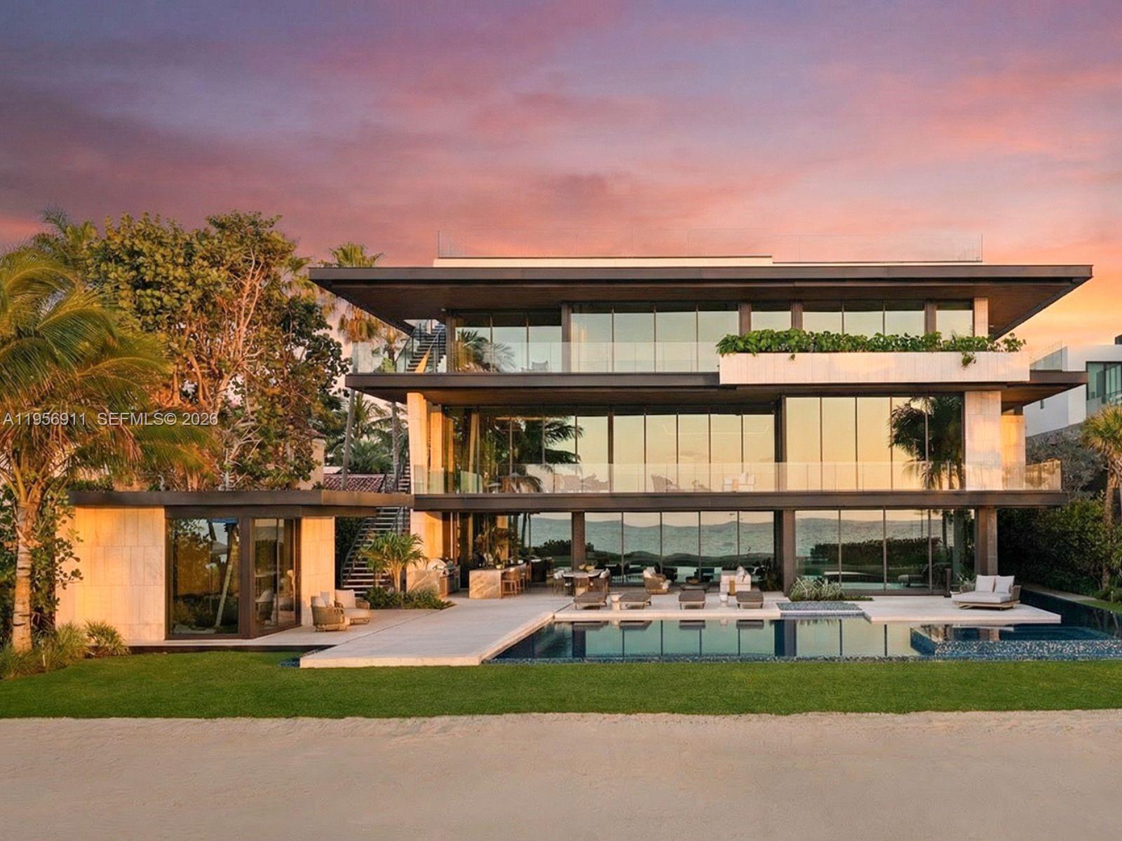 Step Inside With Me! 255 Ocean: the most magnificent modern mansion debuts at a new price on the private sands of Golden Beach. Newly completed by TREO and SDH Studio, the façade is draped in greenery and natural stone with no stucco in site. Experience 23’ ceilings upon arrival, a sculptural travertine staircase, and infinite ocean views. Book-matched travertine floors echo the organic movement of the sand. White oak millwork and paneled walls exclusively by La Dolce Vita introduces Italian craftsmanship at every turn. The hosting spaces unfold seamlessly from the beachside entertainment level to the formal salon with centerpiece marble bar, and the ultimate upstairs media room. The oceanfront kitchen showcases monolithic curved islands, Dornbracht fixtures, a breakfast TV lounge, and chef's kitchen. The primary suite is clad in warm oak featuring dual dressing rooms, a hand-carved soaking tub sculpted from a single block of stone and a nearby office suite. Designed for longevity, wellness is woven throughout - fitness studio, massage room, sauna, cold plunge, and enhanced air quality. Outdoors, a 75’ lap pool pairs with an oversized jacuzzi, while the rooftop offers an additional pool & spa overlooking the beach. More highlights include theater, dedicated office, guest house, 2 elevators, staff room, garage, carport and motor court. Contemporary yet warm, tropical yet refined, this home is designed not just to be admired, but to be lived in. 1 of only 60 homes on the sand.