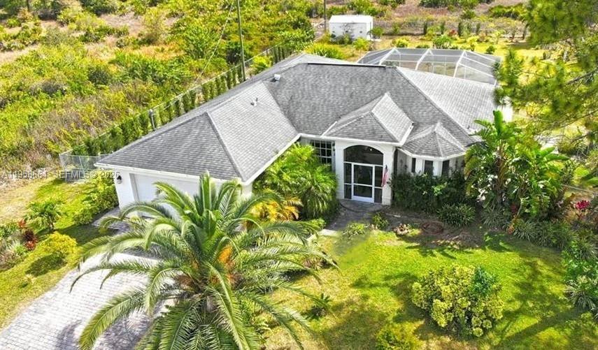 Priced to Sell "Your PERFECT 3 Bedroom and 3 Bathroom Home!" yes, a 3/3, A real "Paradise" A Home that comes on a huge wooded 1/2 Acre Lot. With screened Pool lanai area and Solar panels that keep your pool under controlled temperature, this Home is where you can move right in and have Everything you want . Great News .. You have just found it! This highly Customized Home features 10' ceilings that soar over the imported Travertine Marble floors. It's filled with very high end details like 8' Doors, Custom Lighting, Niches & Arches. Large open Kitchen with custom Cabinets, Granite Counters, Stone Backsplash and Stainless Appliances. Each of the 3 spacious Bedrooms come with their very own individual custom Bathroom featuring stylish vessel sinks on marble counters, custom glass shower doors & classy tile work. The private Master Suite features Sliders to the Lanai and big walk in Closets. Huge Lanai and Saltwater system Pool with maximum Paver space over looking the Super Private Mega Backyard with fruit trees