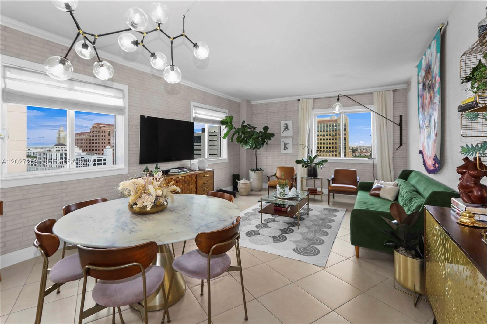 Enjoy elevated city living and skyline views from this light-filled corner residence at Ten Aragon. Rarely available and the largest 2-bedroom, 2-bath floor plan in the building, this exceptional, completely updated home showcases beautifully curated interiors by Moniomi Design, featuring custom details and quality finishes throughout. A welcoming foyer entry leads to spacious open-concept living and dining areas ideal for everyday living and entertaining. The thoughtfully designed split-bedroom layout offers privacy, while large windows fill the home with natural light. The open kitchen features abundant cabinetry and workspace and flows seamlessly into the main living areas. The spacious primary suite includes a walk-in closet and an updated bath. Additional highlights include tile and marble flooring throughout, impact-resistant windows and doors, a generously sized laundry room with full-size washer/dryer and extra storage, and a covered terrace perfect for relaxing, entertaining, or enjoying the city views. Amenities include a heated pool, jacuzzi, fitness center, community room, business center, and 24-hour concierge/security. Ideally located in the heart of Coral Gables, Ten Aragon is just steps from Miracle Mile's renowned restaurants, cafés, boutiques, and entertainment, with convenient access to the University of Miami, Coconut Grove, Brickell, and Downtown Miami.