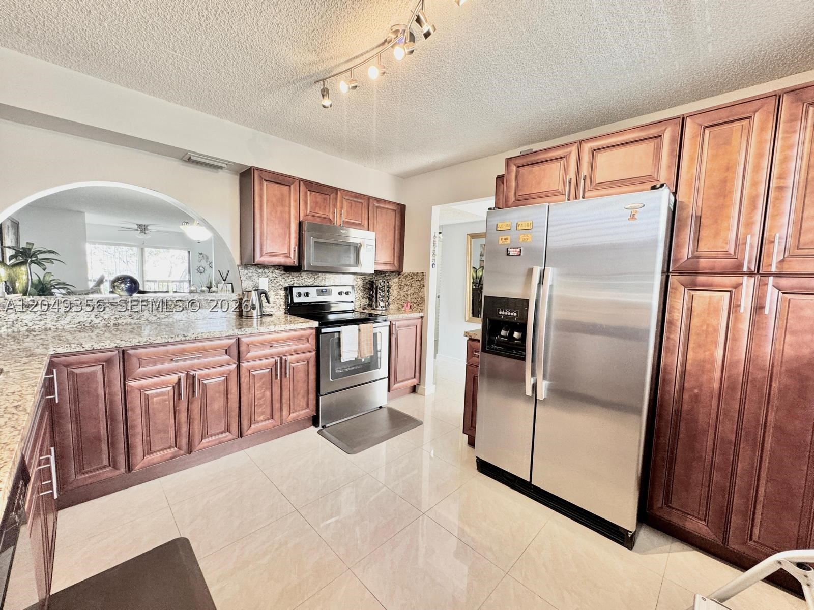 Beautifully Updated & Move-In Ready! Welcome to this spacious 2-bedroom, 2-bathroom condo offering over 1,270 sq. ft. of comfortable living in the desirable 55+ community of Lakes of Carriage Hills. Enjoy relaxing canal views from the oversized enclosed porch, currently used as a cozy TV/family room, adding valuable living space. The renovated kitchen features elegant wood cabinetry, granite countertops, and stainless steel appliances. Both bathrooms have been tastefully updated, and the home boasts ceramic tile flooring throughout, fresh interior paint, and a Large Laundry room with a full-size washer and dryer. Hurricane protection includes an impact window in the primary bedroom and accordion shutters on all other windows and the front door for added peace of mind. Located on the third floor, this meticulously maintained residence is truly turnkey. Residents enjoy an exceptional lifestyle with two heated pools, sauna, tennis courts, shuffleboard, billiards, library, clubhouse, social activities, and more. Don't miss this opportunity to own one of the finest renovated units in the community—schedule your private showing today!