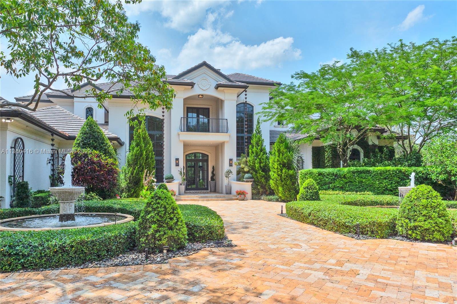 Palatial privately gated estate in the coveted Sunshine Ranches of Southwest Ranches. Spanning over 2.09 acres, this impressive 7 Bed / 7.5 Bath 2-story estate features over 10,200 sqft of unparalleled craftsmanship, with double high volume ceilings throughout. Home Boasts a New dream kitchen complete with custom cabinetry and top-of-the-line appliances. More highlights include a library/office, theatre, gym, multiple living rooms & two luxurious primary suites. Luxurious Estate is protected by all Impact doors/windows & is equipped with a full-home generator, along w/ Savant Home Automation. Backyard is a stunning oasis with a grand-covered patio, New outdoor kitchen, coy pond, basketball court, built-in trampoline, fireplace area, dog park, immaculate landscaping, and green open spaces.