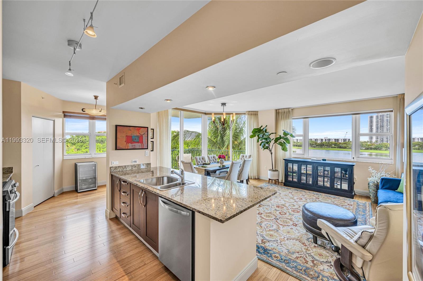 Located in the heart of Aventura on the Circle and adjacent to the Turnberry Isle Golf and Country Club this 2 bedroom 2 bathroom residence offers 1470 sqft of comfortable living with beautiful water and golf course views. This bright corner unit features a private vestibule with only two residences and a proper foyer entry that creates a welcoming arrival. The home is filled with natural light, solid wood floors throughout the main areas of the home. The residence offers an open layout with a great balance of space and privacy along with southwest exposure and stunning sunset views. The kitchen includes a large island a breakfast area, counter seating and ample storage which opens seamlessly into the main living space making it ideal for both everyday living and entertaining. Turnberry Village is a beautifully maintained community with two buildings and resort style amenities that make every day feel like a vacation.  Move in ready and easy to show!