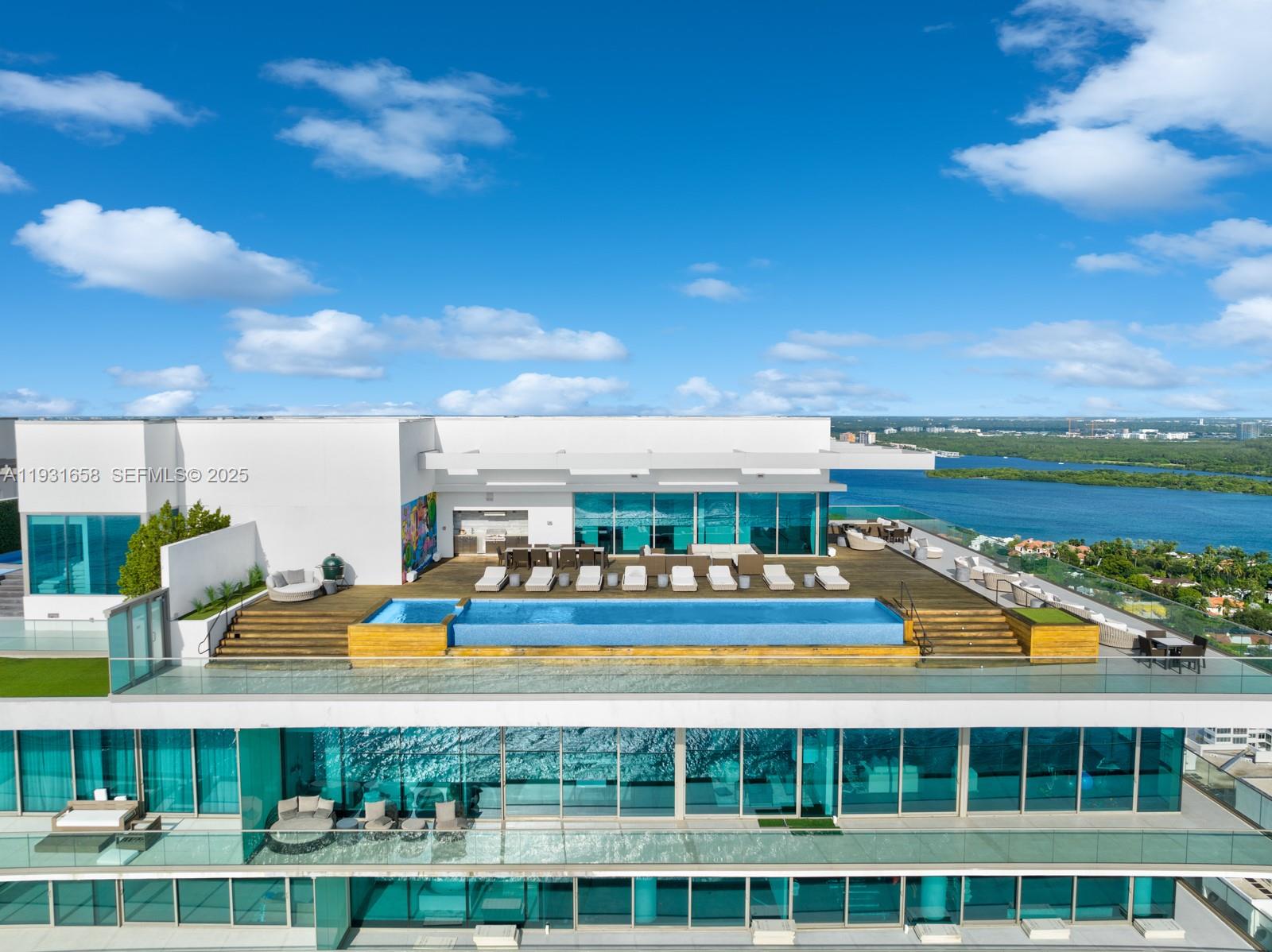 A Crown Jewel in the Sky at Oceana Bal Harbour. Ocean, bay, and luxury converge. This two-story penthouse is a corner unit wrapped in floor-to-ceiling glass and deep terraces, framing uninterrupted vistas of the ocean, Biscayne Bay, and the glittering Miami skyline. A private elevator foyer opens into an expansive 8993 sqft great room flooded with natural light. The open gourmet kitchen seamlessly connects to the dining and living areas and to the oversized terrace for a true indoor-outdoor living. 6 beds and 8 full baths plus 2 half baths, office, media room with top of the line finishes. The rooftop 7000 sqft terrace features a private pool, jacuzzi, and outdoor kitchen. Where the ocean meets the sky.