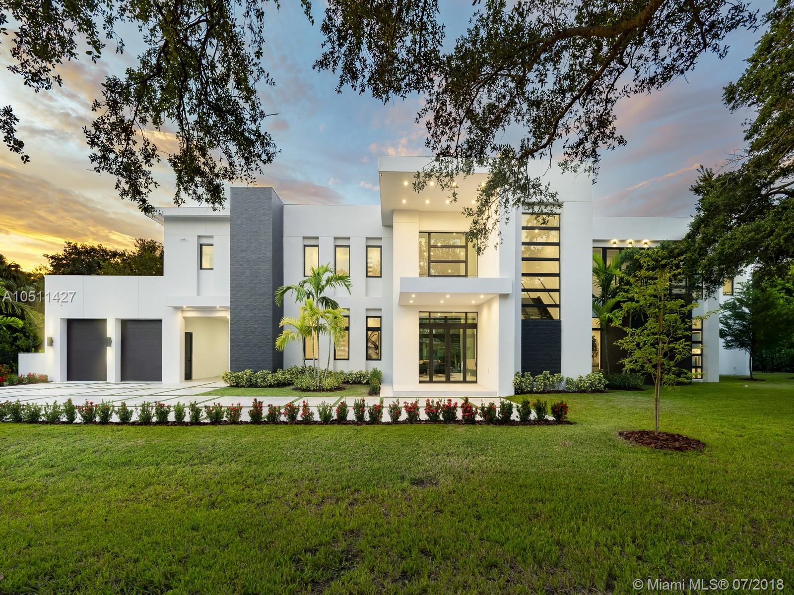 Striking 2018, Brand-New Estate built with the finest finishes. Enormous windows and doors offering plenty of natural light making this floorplan spectacular. European Kitchen cabinets, Quartz counters, Wolf & SubZero Appliances. Picture-perfect entertaining Kitchen and Family room area while enjoying flow through yard views. Estate offers 6 en-suite bedrooms with finished closets, a Media Room or additional 7th bedroom. Master Suite offers balcony overlooking the extravagant resort style pool & backyard area. Master Bath has double vanities & water closets, floating tub, & grand shower. LED Lighting & porcelain floors throughout. Other features: large covered terraces, summer kitchen, detached 2 car garages + carport.  Located in very quiet and private street. Premier Pinecrest Schools.