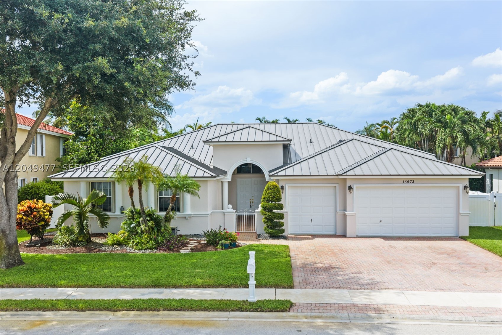 Luxury in the prestigious Estates of Pembroke Shores. This exceptional 5-bedroom, 3-bathroom residence offers an impressive combination of elegance, comfort, and modern upgrades. Featuring a brand-new metal roof, accordion shutters throughout, beautiful plantation shutters in select rooms, newer kitchen appliances and washer and dryer 2 yrs. Newer Water Heater - 2025, 2 A/C units - 2025 & 2017.  Wait until you see the Laundry room - This meticulously maintained home is designed for peace of mind and effortless living also equipped with whole house surge protection.

The expansive floor plan showcases soaring ceilings, spacious living areas, and an ideal layout for entertaining family and guests. The beautifully appointed kitchen features a large island and flows seamlessly into the main living spaces. A private rear bedroom offers the perfect retreat for guests, extended family, or a home office.

Step outside to your own private backyard oasis, complete with a heated saltwater pool - resurfaced in 2021, and low-maintenance artificial grass surrounding the home—perfect for children, pets, and year-round enjoyment. The three-car garage provides exceptional convenience and storage. Additional feature includes French Drain to the road.

Located in the highly sought-after Estates of Pembroke Shores, this move-in-ready residence delivers the perfect blend of luxury, privacy, and resort-style Florida living. A rare opportunity to own a truly special home in this community.