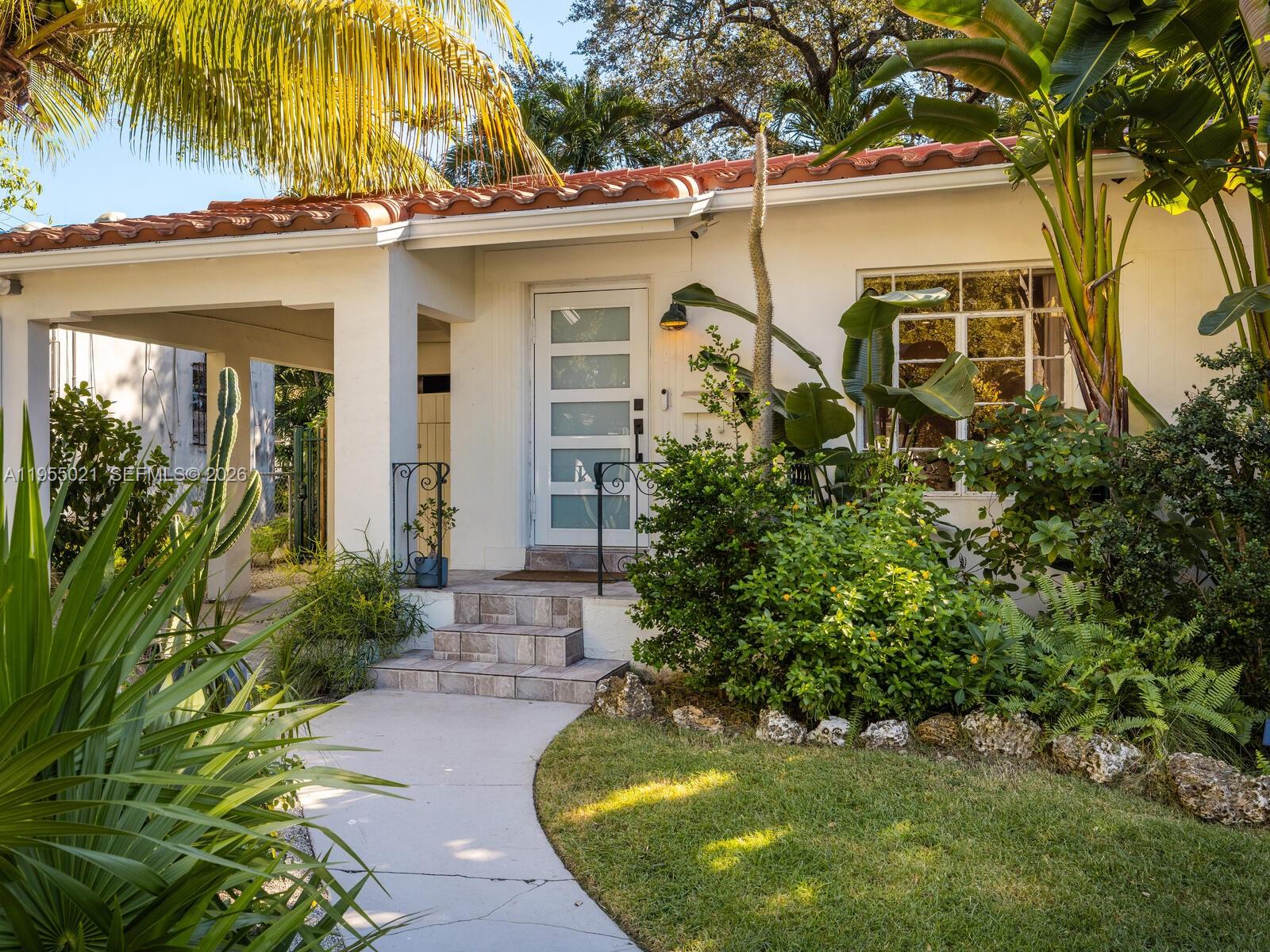 Welcome to Blue Palm in Spring Garden! Tucked inside one of Miami's most enchanting historic enclaves, this substantially updated 2bed/1bath bungalow is airy, inviting and rich with period character. Sunlight fills the open living areas, and the modern kitchen features a generous cooking island with bar seating. The dreamy Florida room with wraparound jalousie windows is the perfect spot to work, create or unwind. Two comfortable bedrooms with custom Elfa closet systems and a refreshed bath complete the interior. Step outside to a lush private oasis with native plantings, premium turf and a pergola-shaded patio. Separate laundry room and shed add convenience. Additional updates: new roof (2025) and updated plumbing and electrical. Spring Garden is a micro-neighborhood with tree-canopied streets and abundant wildlife just minutes from Downtown, Brickell, the Heath District and the airport!