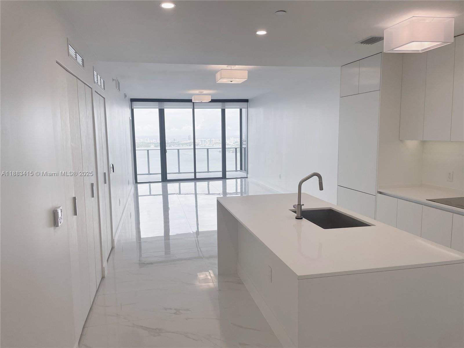 This brand new luxury condo has panoramic views of Biscayne Bay, all the way from Key Biscayne to Fort Lauderdale and the ocean beyond.  The 2 bedroom, 3 full bath with den features high end appliances, floor to ceiling sliding glass doors, upgraded fixtures, glass showers and backlit mirrors in all bathrooms, a walk-in closet, new shelving, and automatic shades that include blackout shades in the master bedroom.  Building amenities include a gym, multiple pools, a spa, yoga studio, a basketball court, tennis courts, movie theater, game room, kids playroom and outdoor grilling areas. The property is located in Edgewater and is just minutes away from Midtown, Wynwood, Miami Beach and Miami International Airport.  Take the opportunity to live in Miami’s newest waterfront condo.
