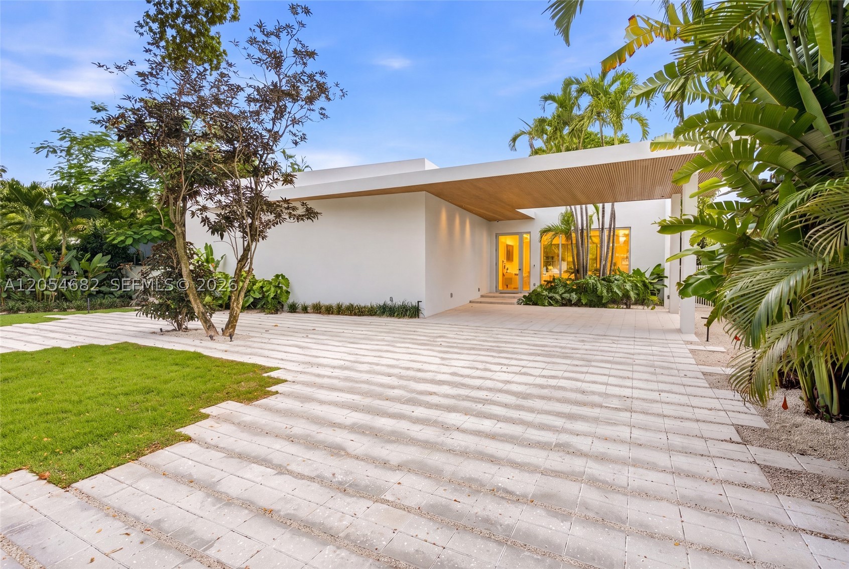 Stunning new construction modern residence that sits on an expansive 10,800 SF lot and offers 3,445 SF of
thoughtfully designed living space. Featuring 4 bedrooms, 4.5 bathrooms, plus a private office, the home blends
architectural sophistication with everyday functionality. Designed to maximize natural light, the open-concept
layout showcases soaring ceilings, designer lighting, and seamless indoor-outdoor flow. The chef’s kitchen is a true
centerpiece complete with custom cabinetry, high-end integrated appliances, and a striking waterfall island perfect
for both entertaining and daily living. Floor-to-ceiling glass doors open to a resort-style backyard featuring a pool,
covered terrace, summer kitchen, and multiple lounge areas creating the ultimate setting for entertaining. The
primary suite offers a private retreat overlooking the pool, with a spa-inspired bathroom featuring dual vanities,
soaking tub, walk-in shower, and a custom closet. Three additional ensuite bedrooms provide comfort and privacy
throughout. Additional highlights include a spacious office, and curated finishes that elevate every corner of the
home. A perfect blend of modern design, luxury, and livability in the heart of Miami Springs.