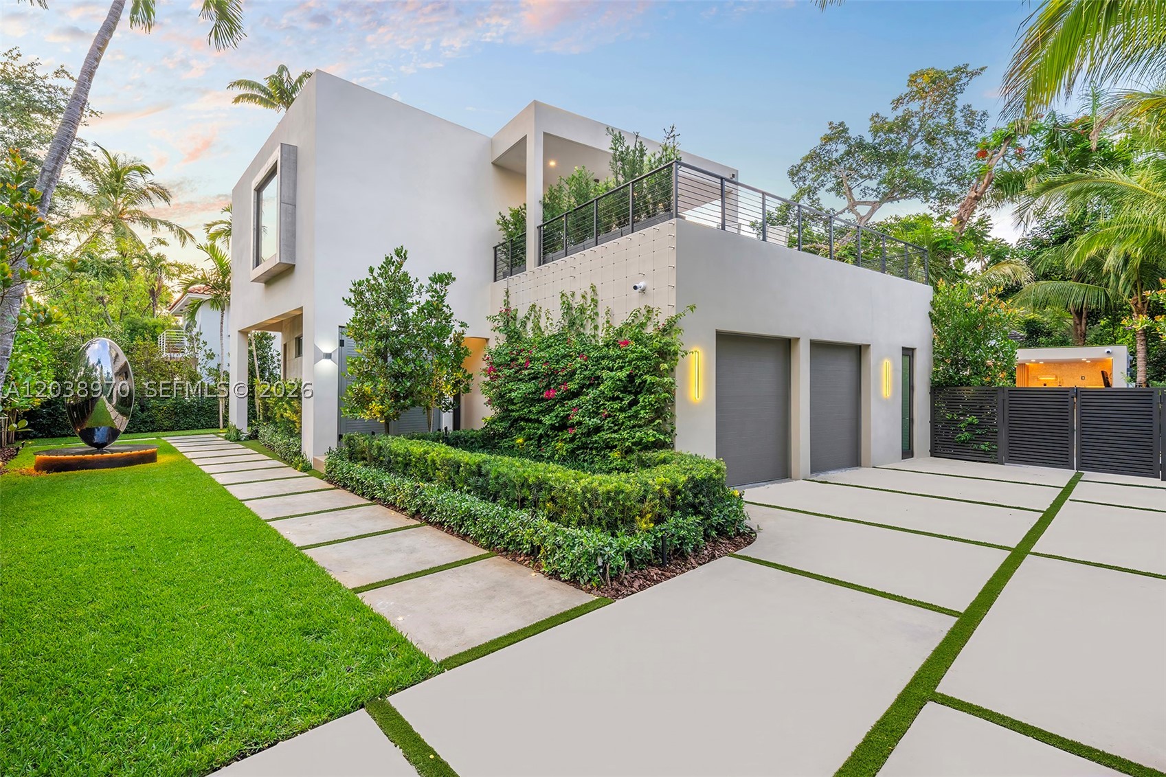 Exceptional South Coconut Grove modern estate situated on an oversized lot along one of the neighborhood's most desirable tree-lined streets. This 5BR/6.5BA residence offers approximately 5,445 SF of thoughtfully designed living space featuring soaring ceilings, elevator, Wolf & Miele kitchen, expansive terraces, designer finishes, motorized shades, and fully integrated Crestron smart-home technology. Resort-style outdoor amenities include a stunning pool and spa, luxury cabana, outdoor entertaining spaces, and lush tropical landscaping with mature trees and layered privacy plantings creating a true private sanctuary. Ideally located near top-rated schools, marinas, parks, dining, and shopping.