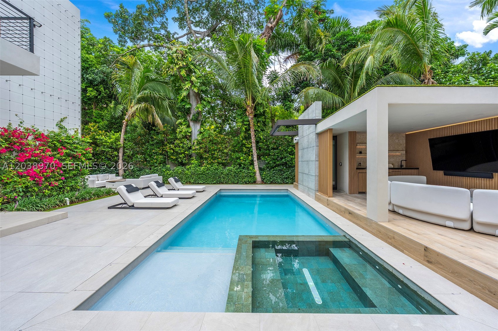 Exceptional South Coconut Grove modern estate situated on an oversized lot along one of the neighborhood's most desirable tree-lined streets. This 5BR/6.5BA residence offers approximately 5,445 SF of thoughtfully designed living space featuring soaring ceilings, elevator, Wolf & Miele kitchen, expansive terraces, designer finishes, motorized shades, and fully integrated Crestron smart-home technology. Resort-style outdoor amenities include a stunning pool and spa, luxury cabana, outdoor entertaining spaces, and lush tropical landscaping with mature trees and layered privacy plantings creating a true private sanctuary. Ideally located near top-rated schools, marinas, parks, dining, and shopping.