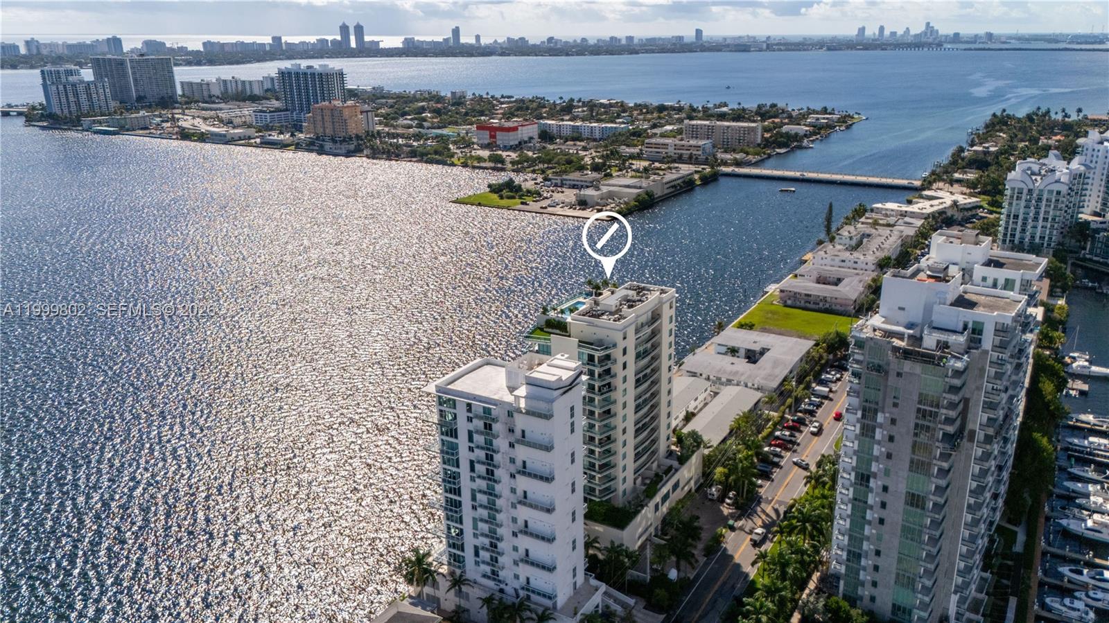 Experience luxury in this stunning 2-story flow-through at Cielo on the Bay, a boutique building with only 35 units. Elevator opens to your private foyer, revealing sunlit spaces with panoramic Biscayne Bay views from sunrise to sunset. Upstairs, two bedrooms with en-suite baths offer water vistas—wake up to shimmering bay views from your bed or shower. Enjoy rooftop pool, hot tub, gym, and community room with water views. Features include a private balcony, covered parking with EV charging, community boat dock, and access to the upcoming 9,000 sqft waterfront park, Island Walk. Pet-friendly, in North Bay Village, between Miami and Miami Beach, steps from fine dining and vibrant nightlife.
