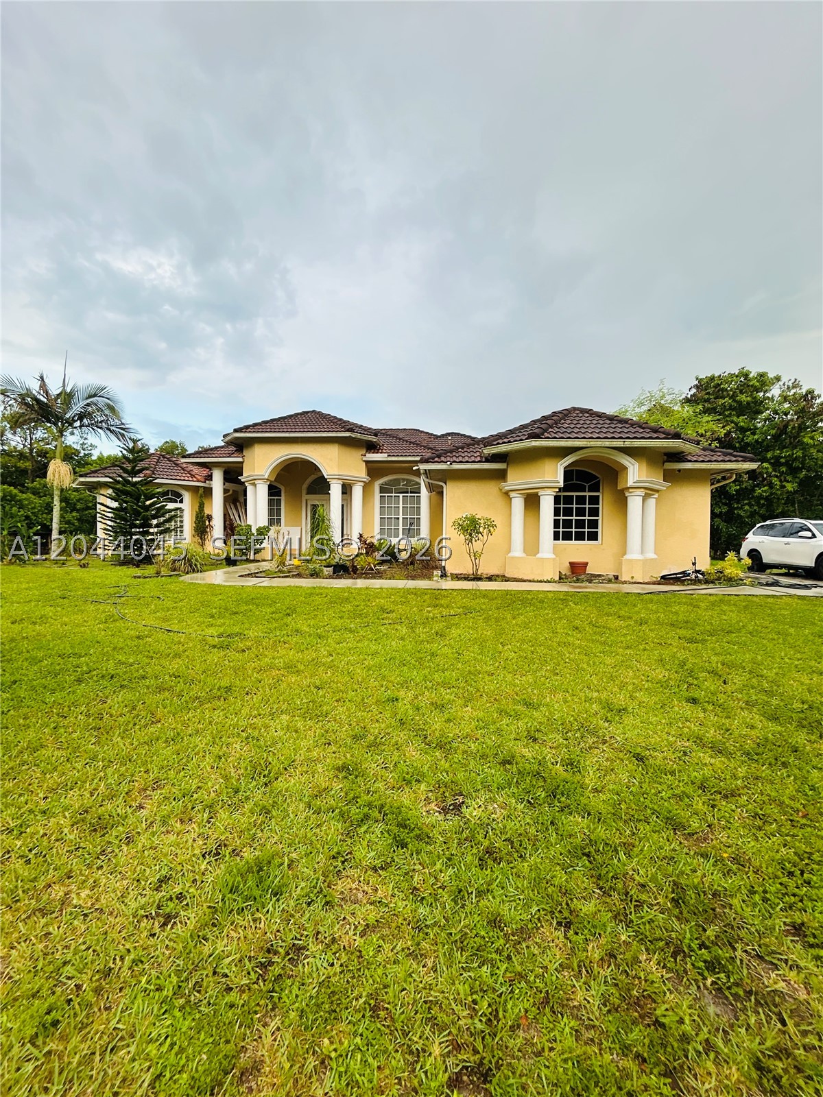 COME LIVE AT THE ACREAGE! FLORIDA LIVING AT ITS FINEST! 1.29 ACRE LOT beautiful Single Story Mediterranean Home with 4 Bed / 3.5 bath PLUS a Den currently used as an office . Property includes, 2 car garage, High Ceilings, archways, 2026 UPDATED Opened concept Kitchen with chef island and all Stainless Steel appliances overlooking spacious living room area , Tile flooring throughout, Huge master suite bedroom with Roman tub, 3 bedrooms with ample closet storage and two additional full bathrooms, cabana half bath which leads out onto the huge screened-in patio, and POOL. Property lot includes a variety of fruit trees and lush green landscaping. Located near Royal Palm Beach, Wellington and Loxahatchee with many golf courses, supermarkets, public parks, as well as an array of shopping, dining, and entertainment. A MUST SEE! EASY TO SHOW!!