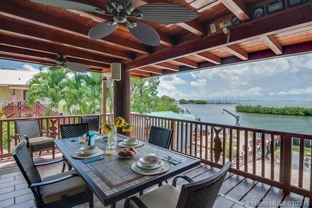 LOVELY BAY VIEW IN THE KEYS!This spectacular private, gated property offers amazing bay views, high ceilings & large covered patios for entertaining and enjoying the sunset views. This spacious property has enough room for an addition, a pool & a tiki and  is in a nice & quiet location.The kitchen & living room have an open concept with 2 bdrms, 2 baths upstairs and 2 bdrms, 1 bath downstairs. Downstairs enclosure with bathroom is permitted, while 2nd room is non-conforming. See Broker Remarks